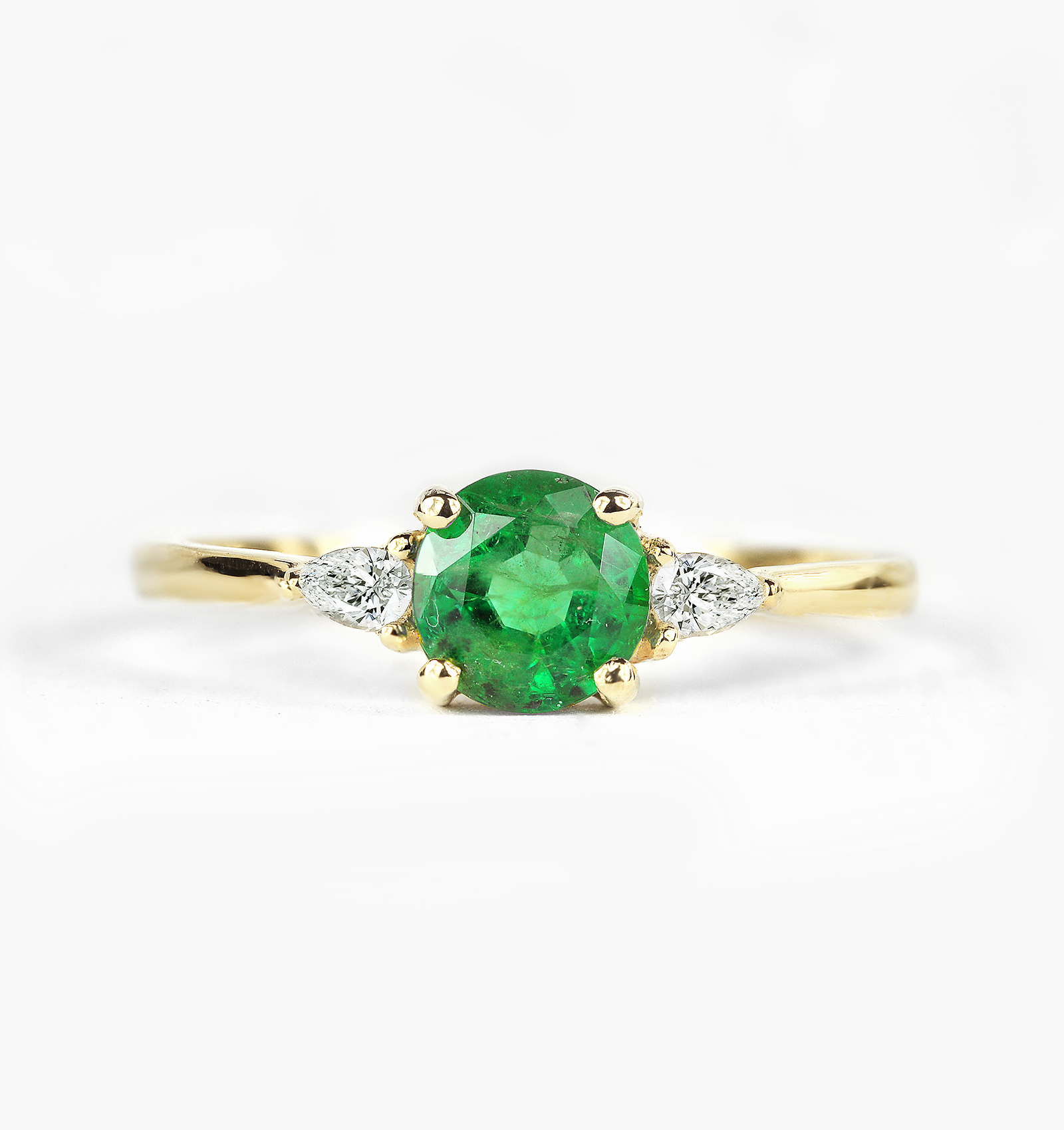 emerald engagement ring with pear cut diamonds