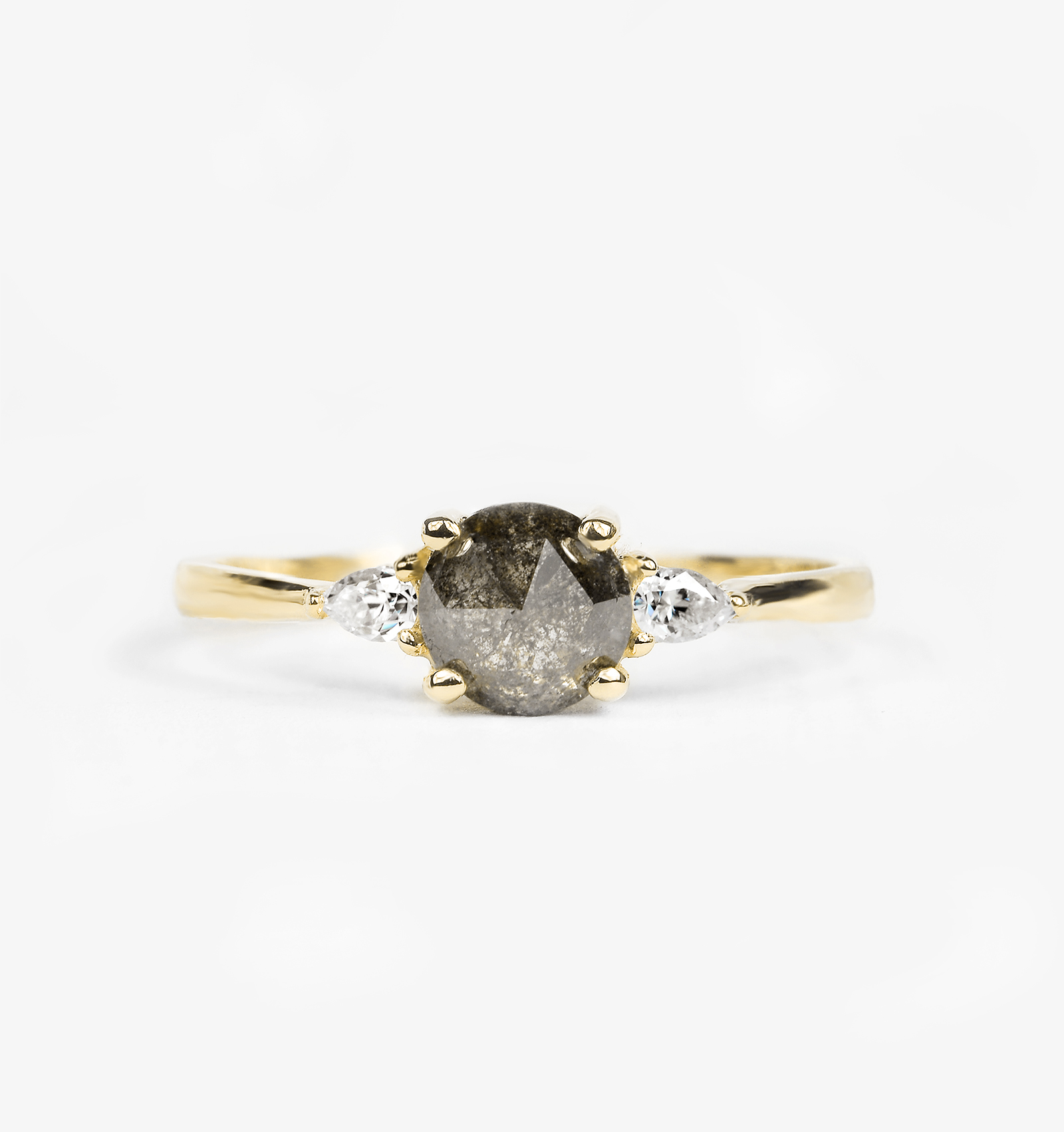 round salt and pepper diamond engagement ring with two pear cut diamonds in yellow gold