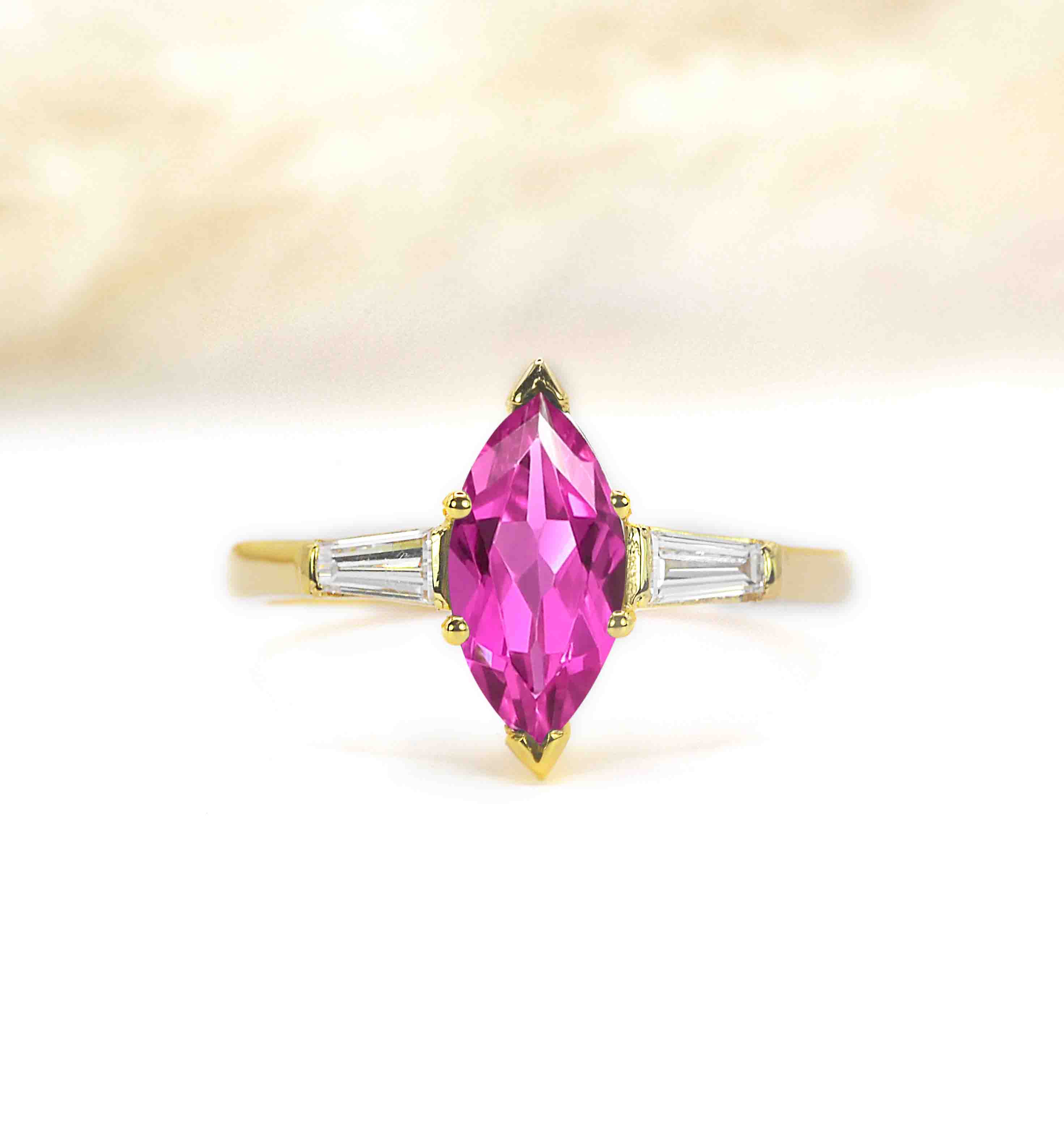 delicate cut pink sapphire ring with hand