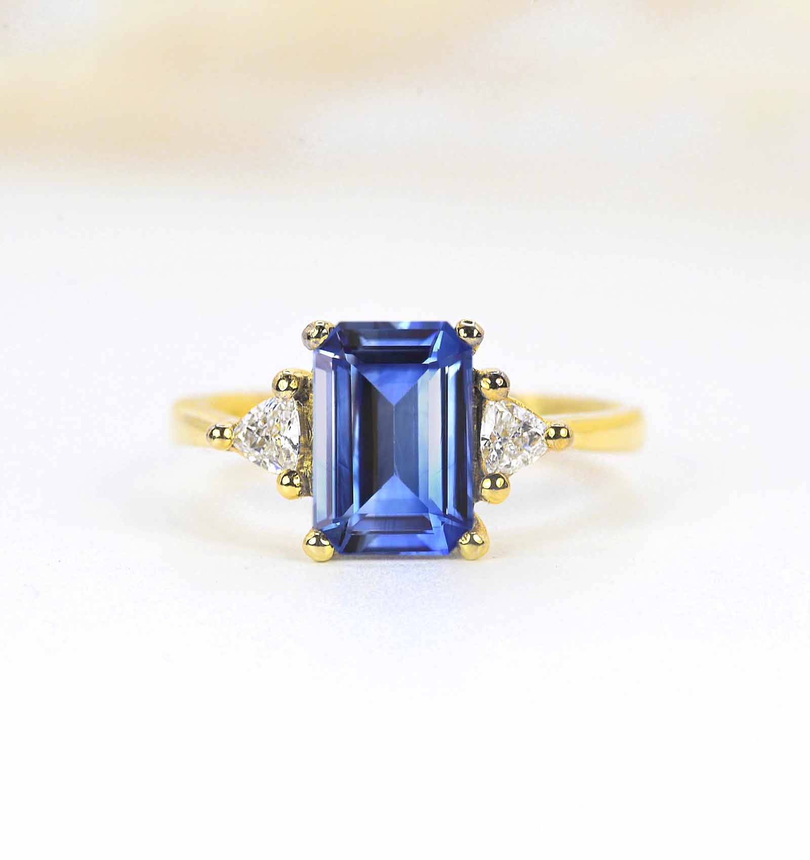 emerald cut blue sapphire three stones ring