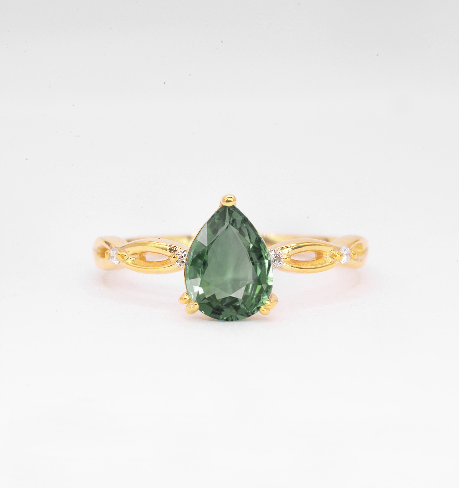 mint green sapphire bridal ring with 8 x 6mm pear mint green sapphire and 1.5mm round diamonds. The unique design of this art deco style ring comes with solid 9ct,14ct or 18ct Rose Gold.