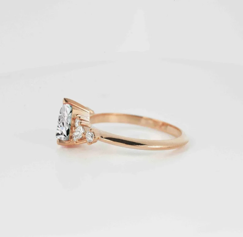 This beautiful pear cut diamond unique ring comes with a center 1.50ct lab grown diamond and white natural diamonds. Available in rose gold, yellow gold, white gold, or platinum.