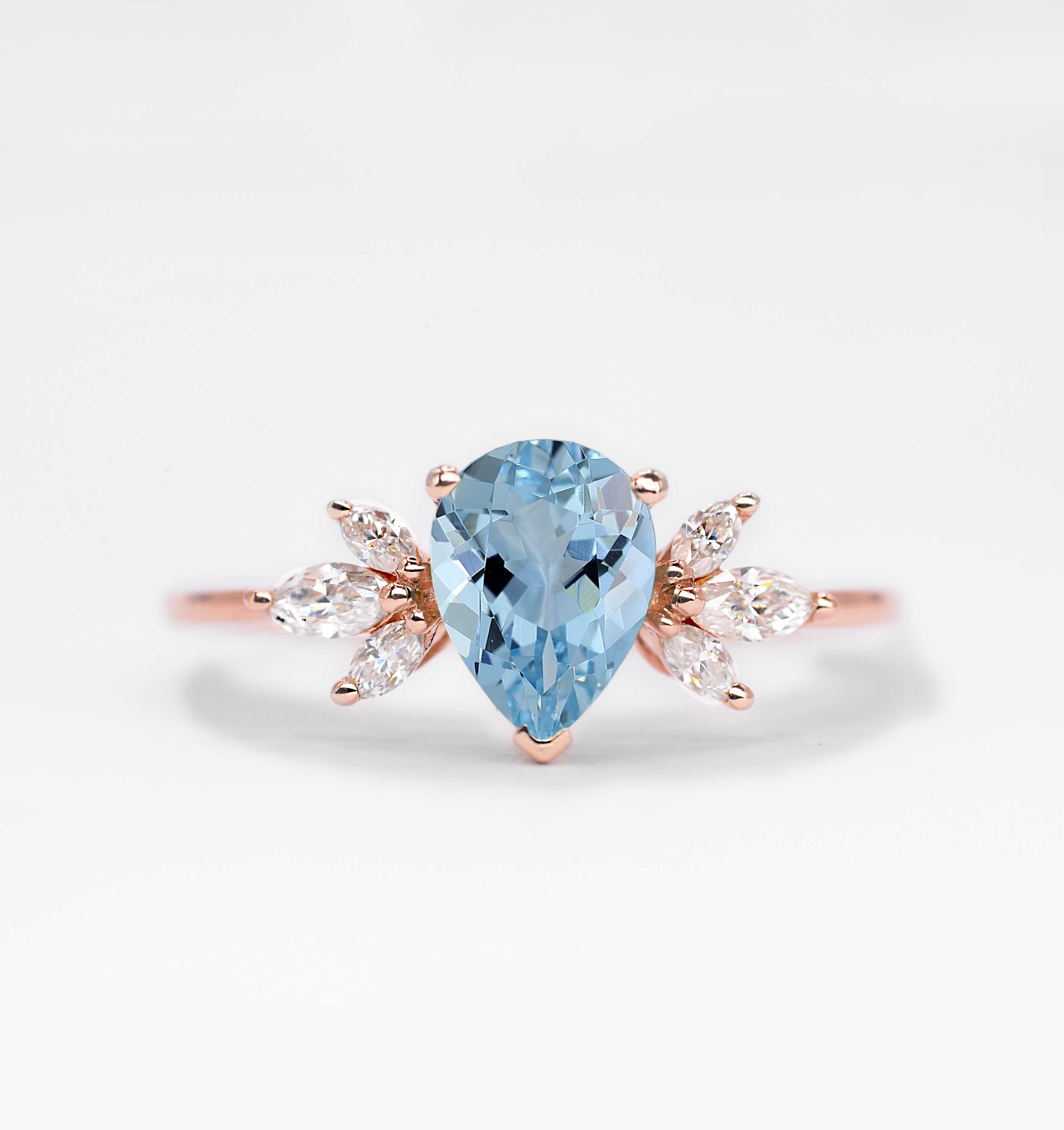 1.5ct pear cut aquamarine and diamond ring with 8 x 6mm aquamarine and white marquise diamonds. The unique design of this art deco style ring comes with solid 9k,14k or 18k gold or platinum.