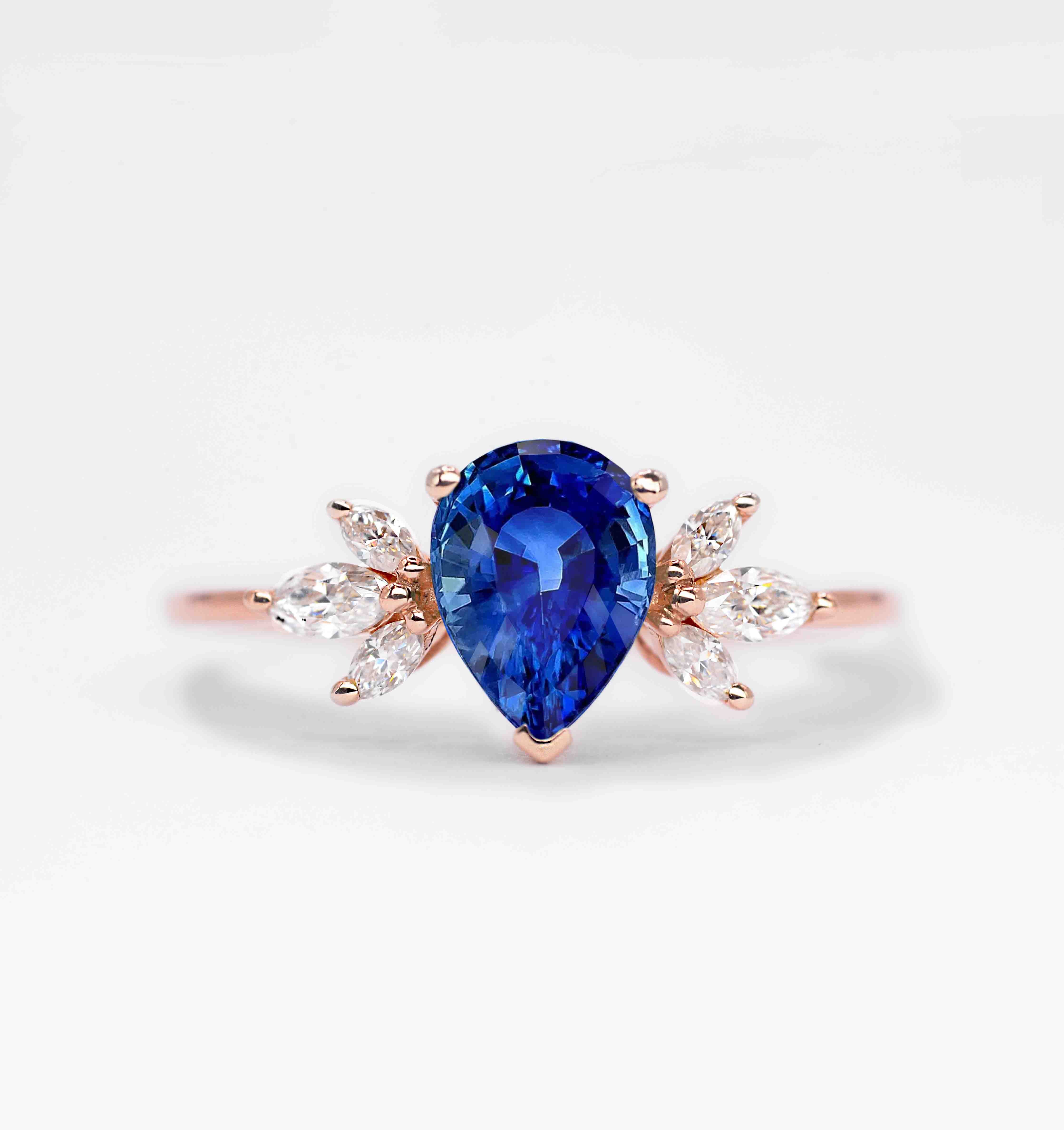 Blue sapphire rose gold luxury ring with 8 x 6mm medium cornflower blue sapphire and marquise diamonds. This unique minimal cluster inspired ring would be a flawless choice to celebrate your special occasions!