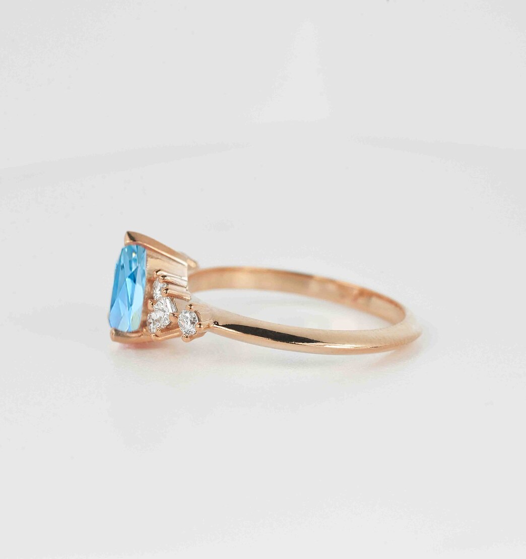 This beautiful pear cut blue topaz bridal ring comes with a center 1.50ct blue topaz and white natural diamonds. Available in rose gold, yellow gold, white gold, or platinum.