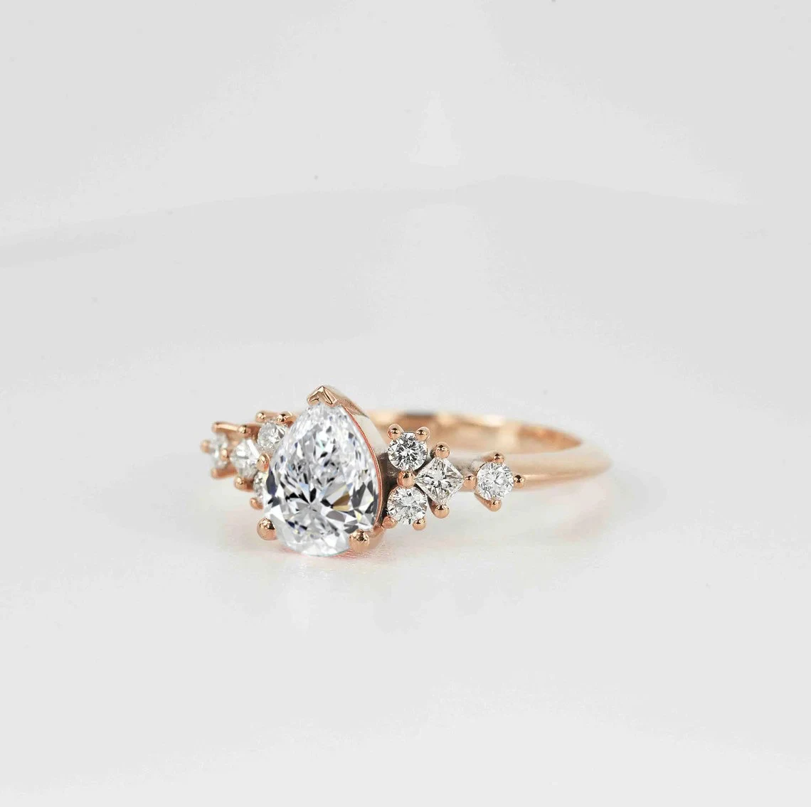 This beautiful pear cut diamond unique ring comes with a center 1.50ct lab grown diamond and white natural diamonds. Available in rose gold, yellow gold, white gold, or platinum.
