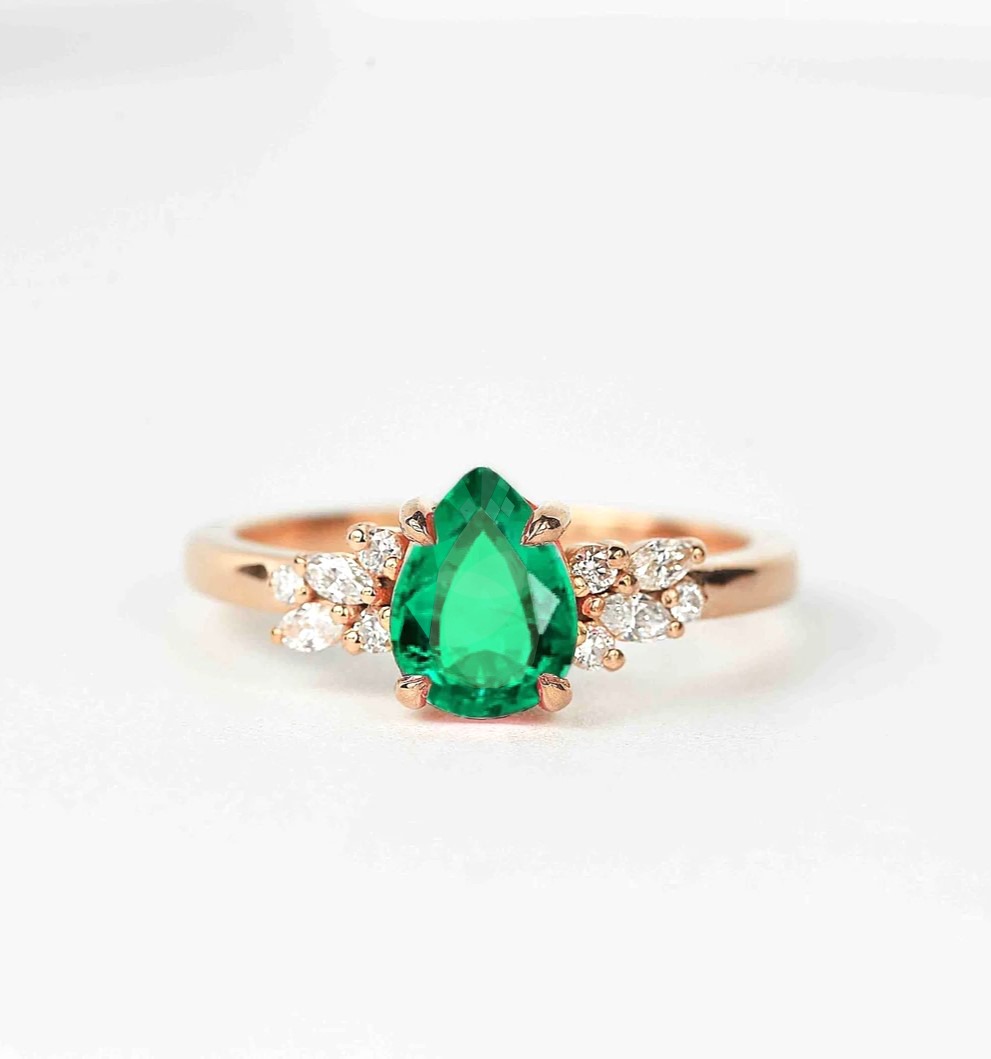 emerald and diamond luxury cluster ring with 8 x 6mm emerald and white accent diamonds. The unique design of this art deco style ring comes with solid 9k,14k or 18k gold or platinum.