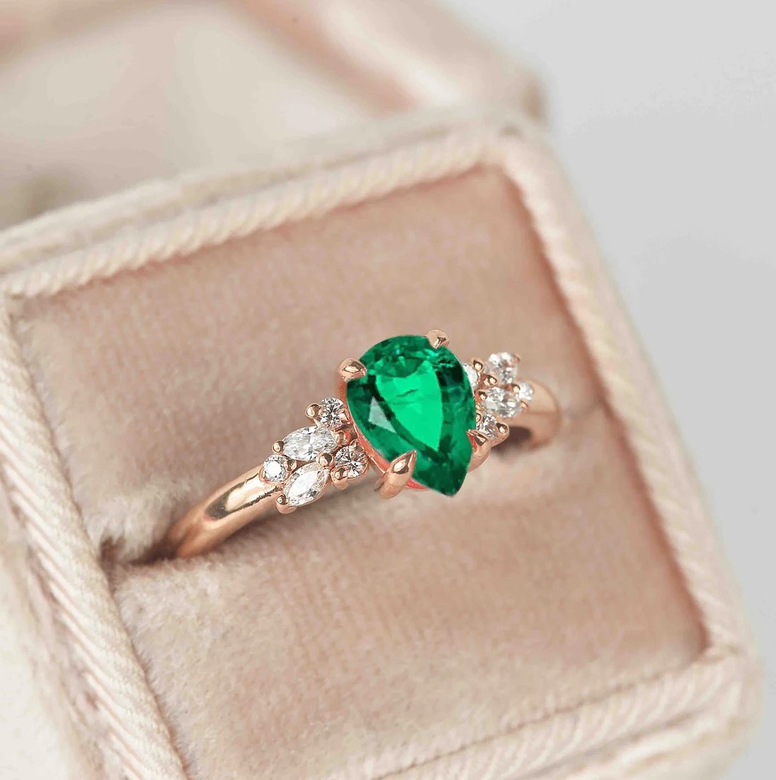 emerald and diamond luxury cluster ring with 8 x 6mm emerald and white accent diamonds. The unique design of this art deco style ring comes with solid 9k,14k or 18k gold or platinum.