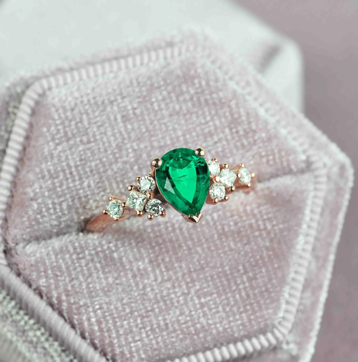 emerald and diamond cluster gift ring with pear shape emerald and round and princess cut accent diamonds.