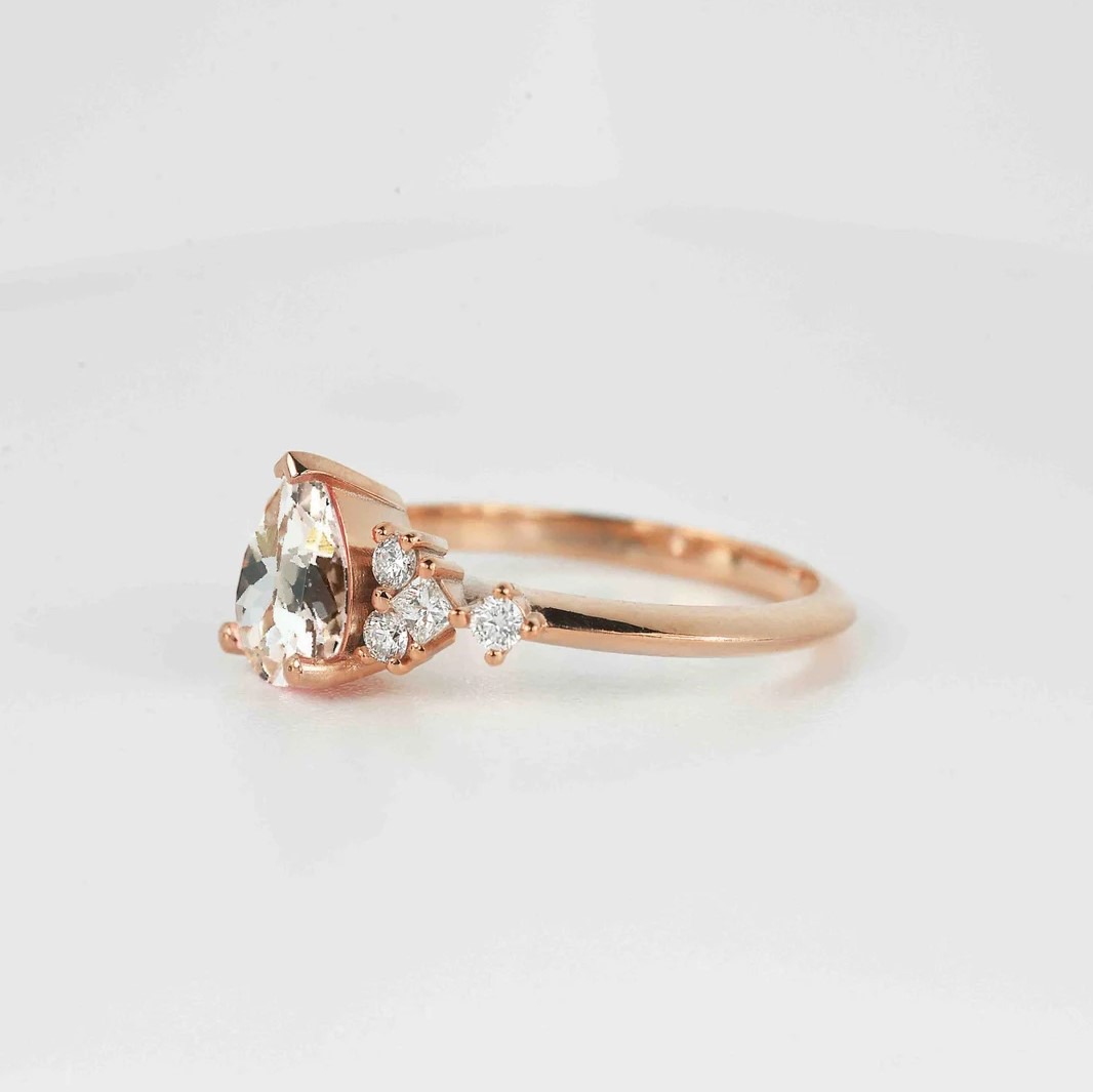 pear cut morganite unique ring with morganite and white accent diamonds. This unique art deco ring comes with solid 9k,14k or 18k rose gold.