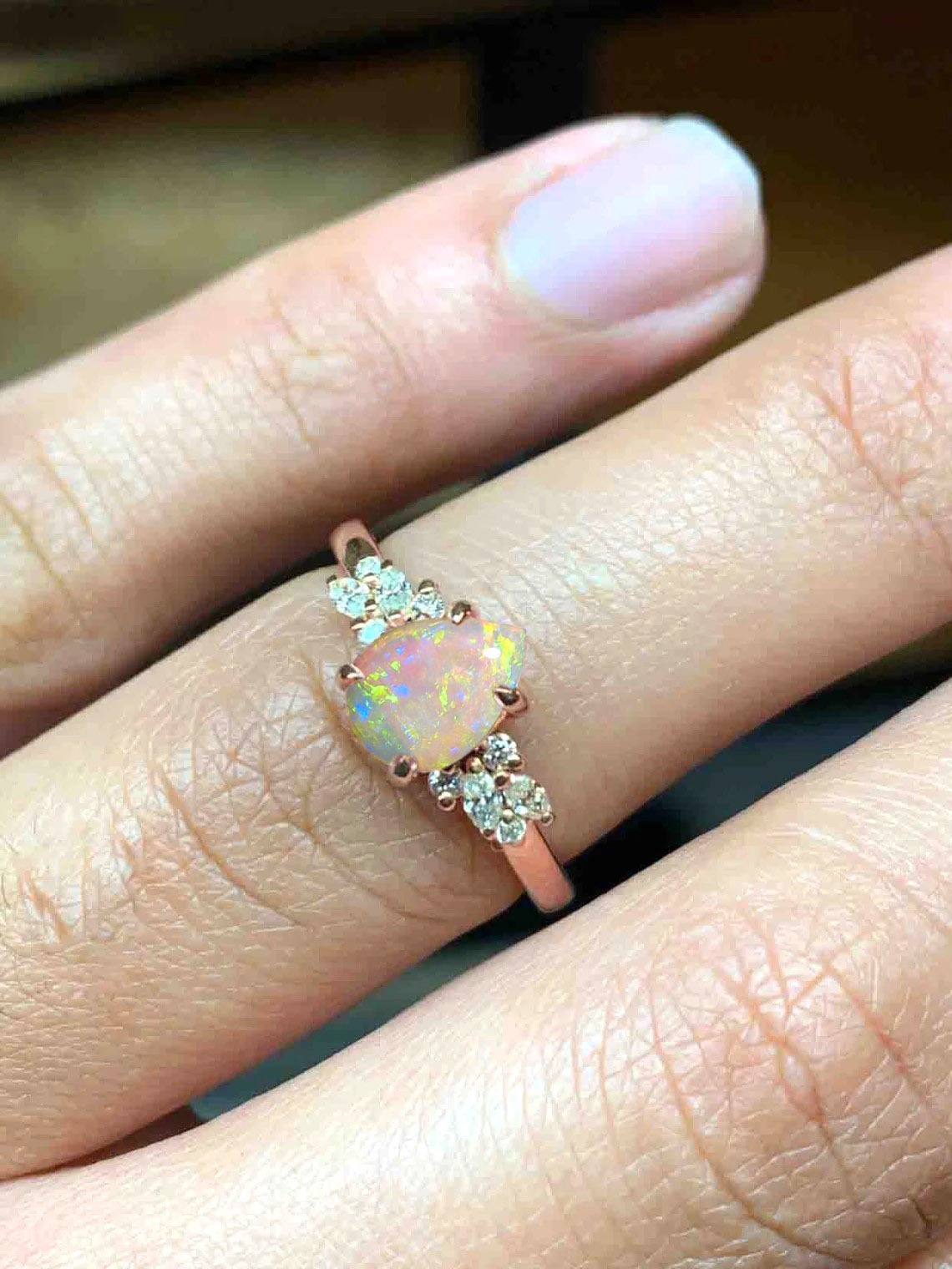 Opal and diamond cluster anniversary ring with 8 x 6mm opal and white accent diamonds. The unique design of this art deco style ring comes with solid 9k,14k or 18k gold or platinum.