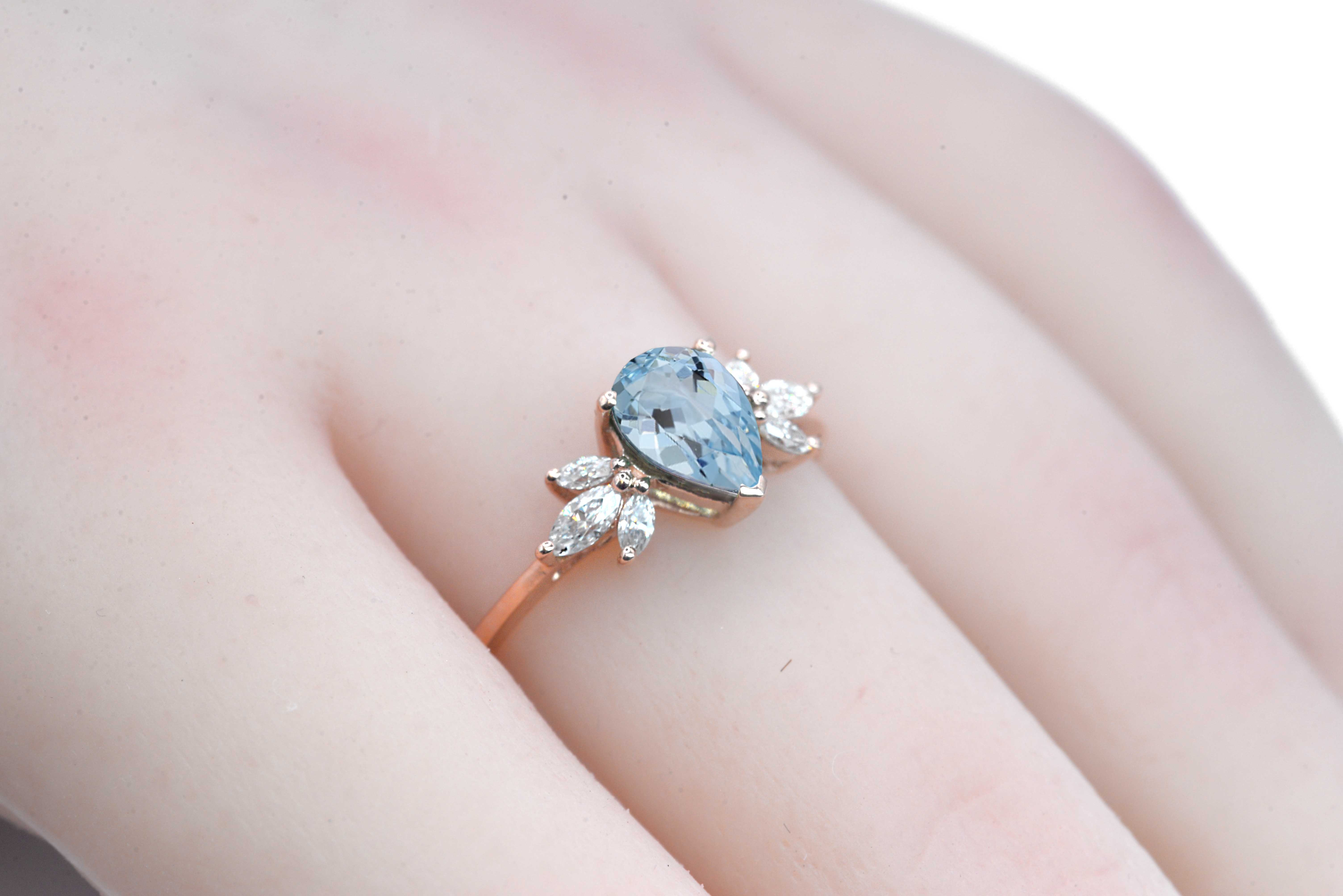 1.5ct pear cut aquamarine and diamond ring with 8 x 6mm aquamarine and white marquise diamonds. The unique design of this art deco style ring comes with solid 9k,14k or 18k gold or platinum.