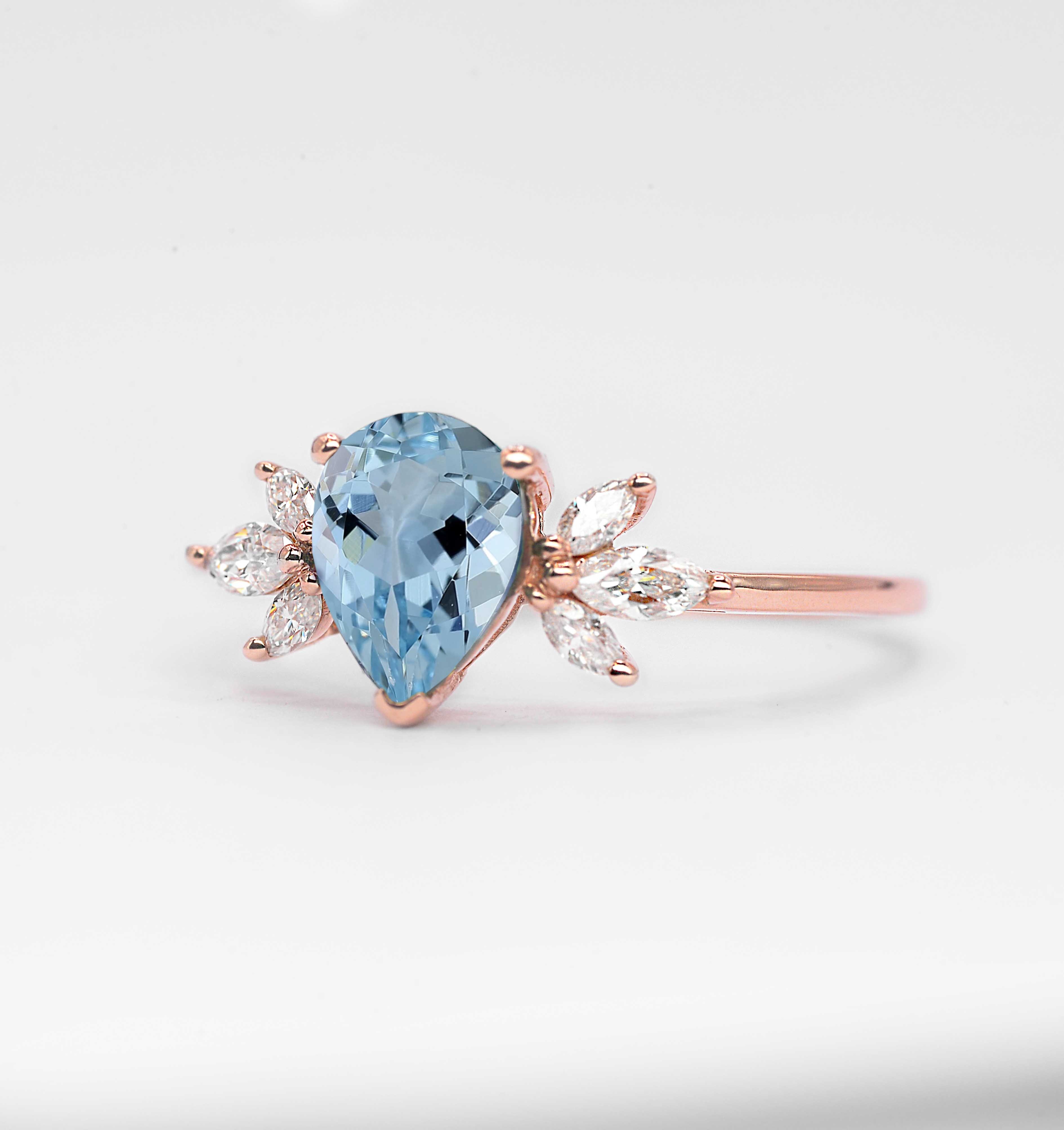 1.5ct pear cut aquamarine and diamond ring with 8 x 6mm aquamarine and white marquise diamonds. The unique design of this art deco style ring comes with solid 9k,14k or 18k gold or platinum.