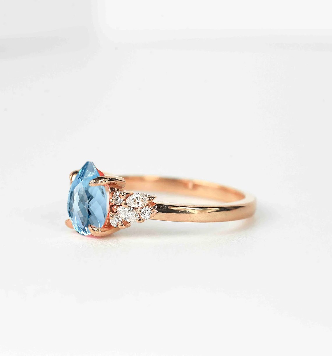 pear aquamarine and diamond ring with aquamarine and white accent diamonds. This unique art deco ring comes with solid 9k,14k or 18k rose gold.