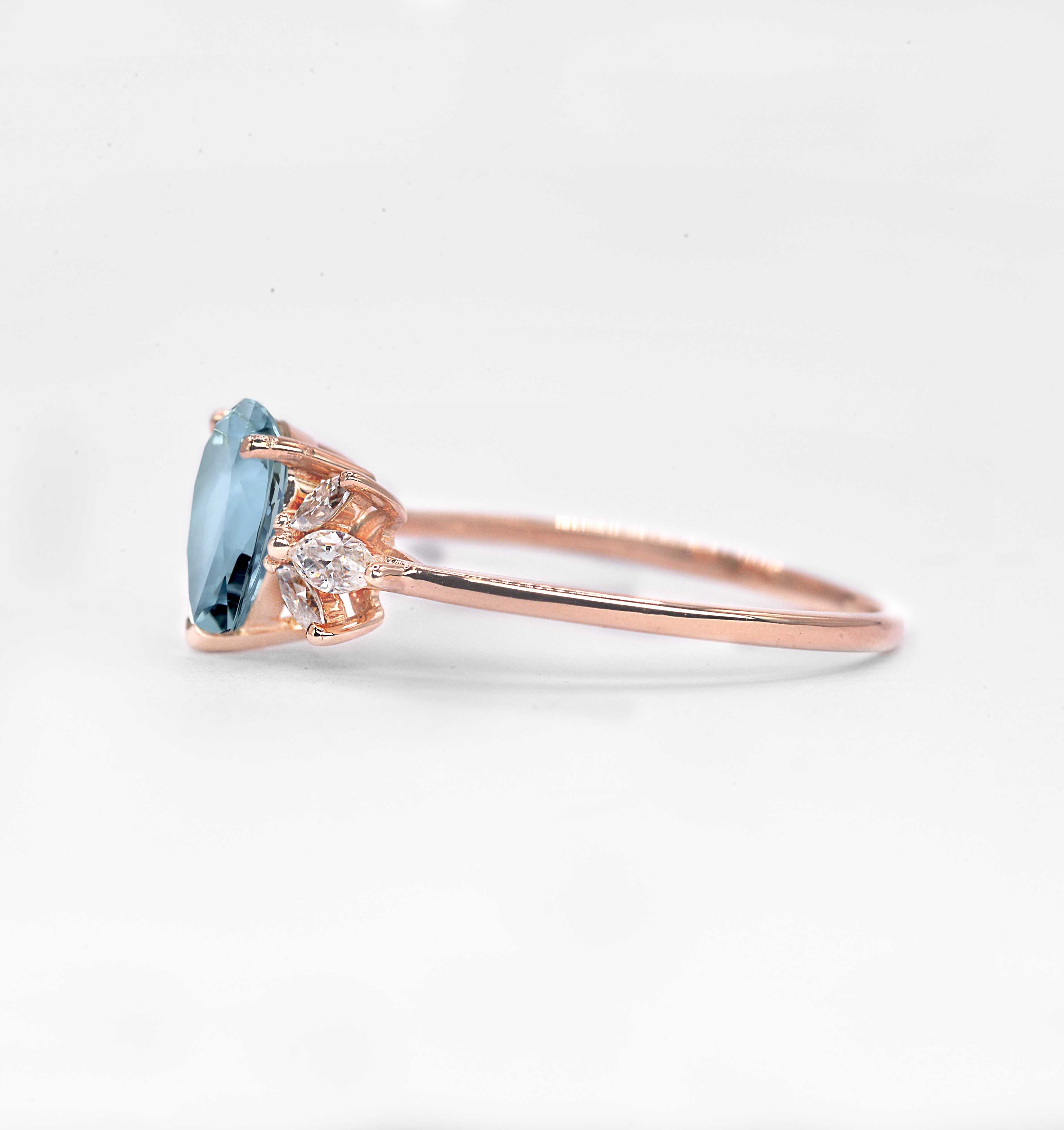 1.5ct pear cut aquamarine and diamond ring with 8 x 6mm aquamarine and white marquise diamonds. The unique design of this art deco style ring comes with solid 9k,14k or 18k gold or platinum.