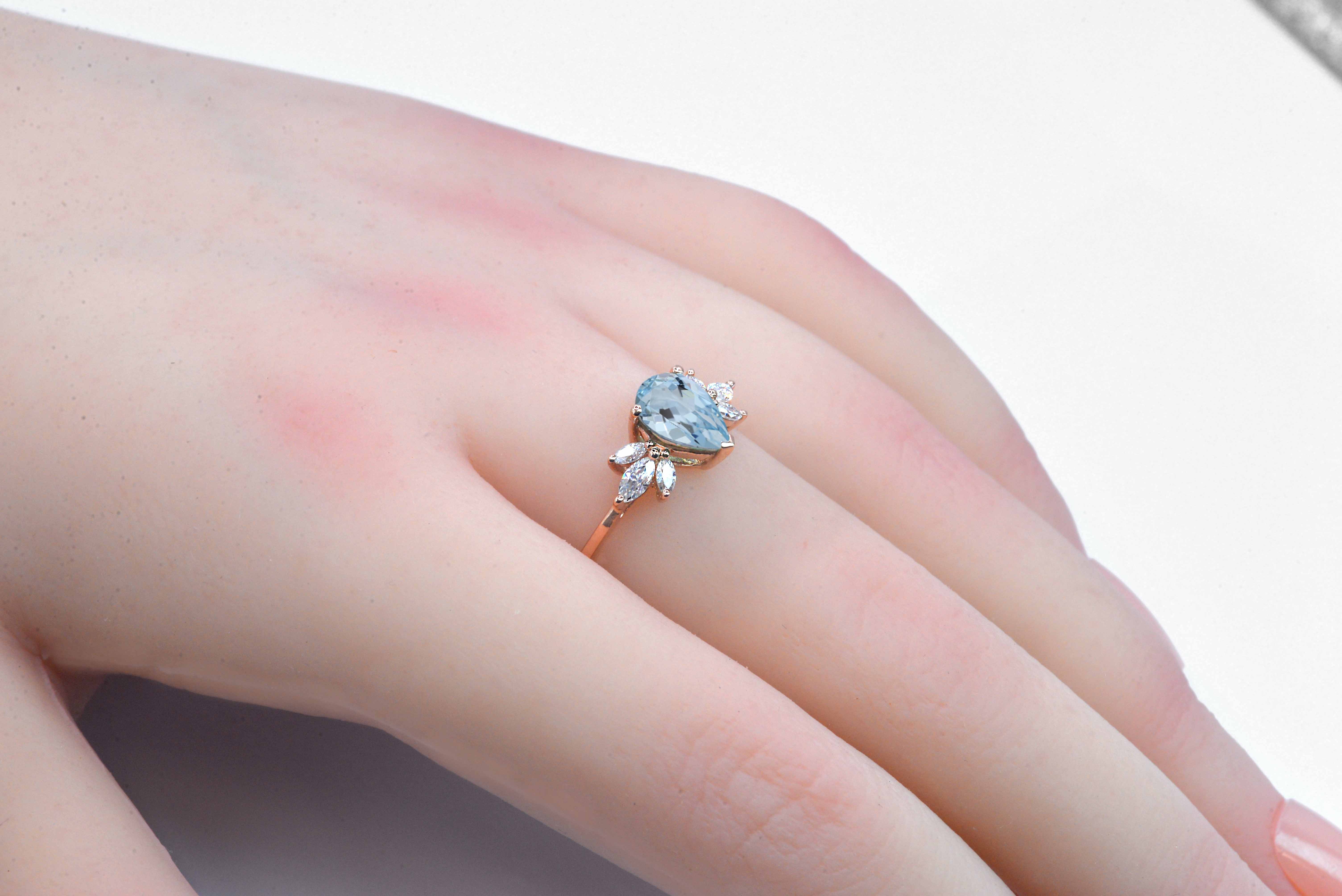 1.5ct pear cut aquamarine and diamond ring with 8 x 6mm aquamarine and white marquise diamonds. The unique design of this art deco style ring comes with solid 9k,14k or 18k gold or platinum.