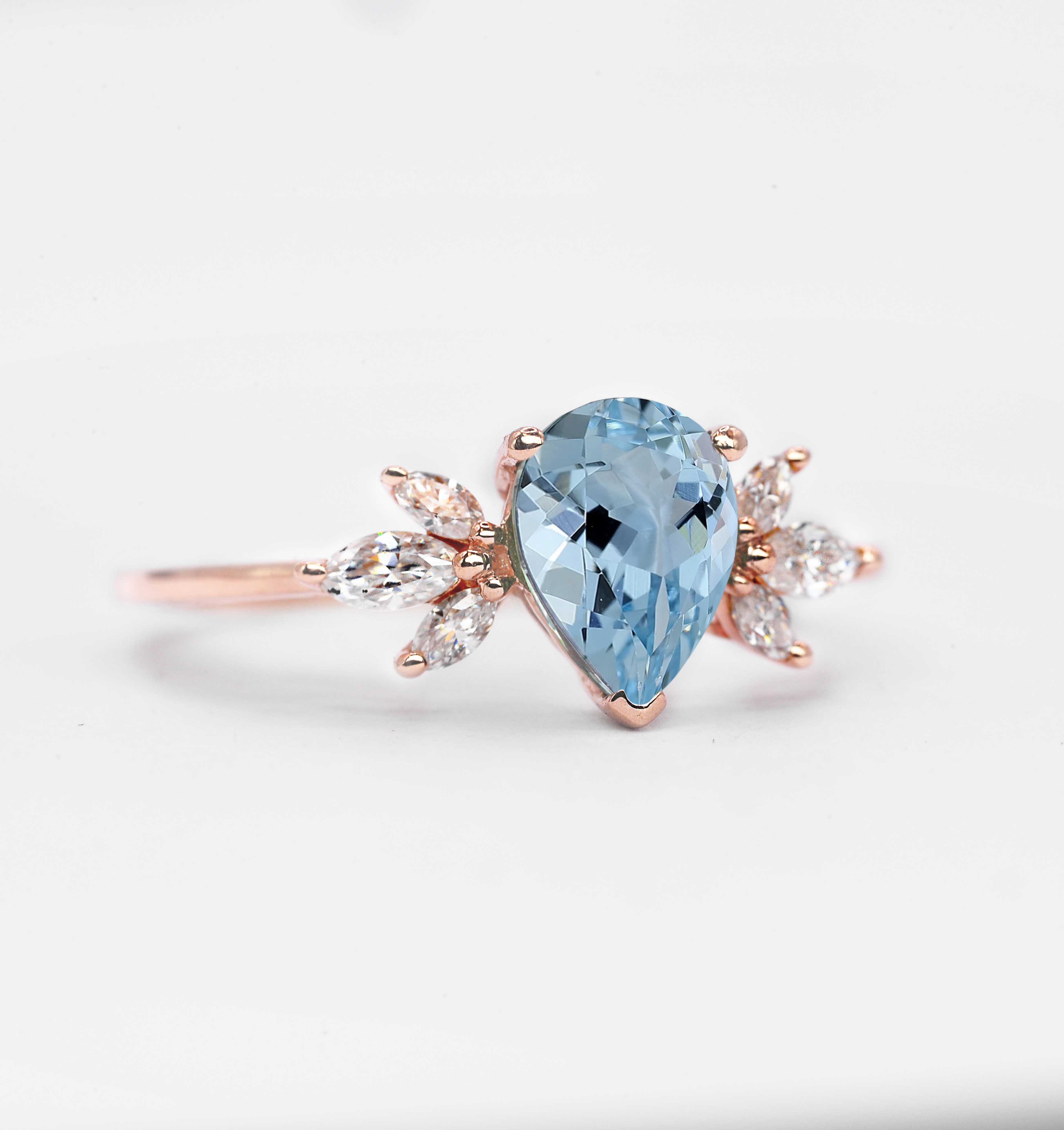 1.5ct pear cut aquamarine and diamond ring with 8 x 6mm aquamarine and white marquise diamonds. The unique design of this art deco style ring comes with solid 9k,14k or 18k gold or platinum.