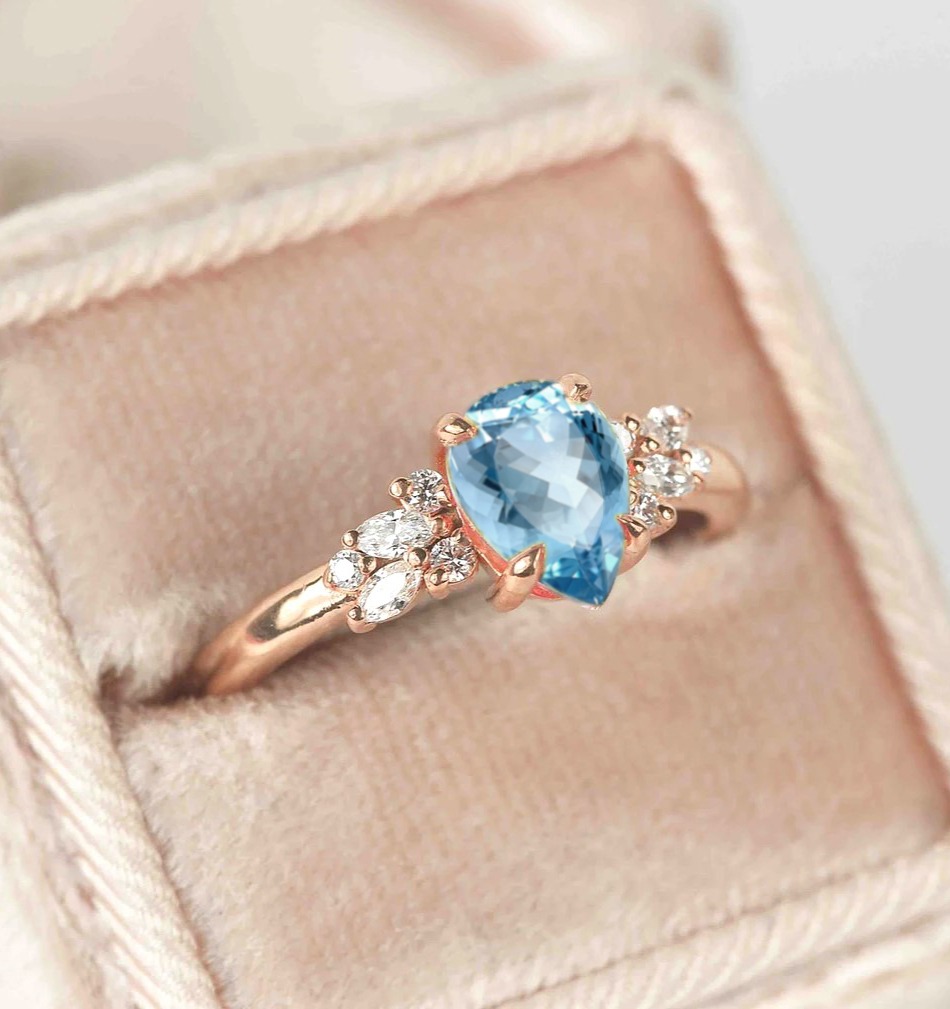 pear aquamarine and diamond ring with aquamarine and white accent diamonds. This unique art deco ring comes with solid 9k,14k or 18k rose gold.