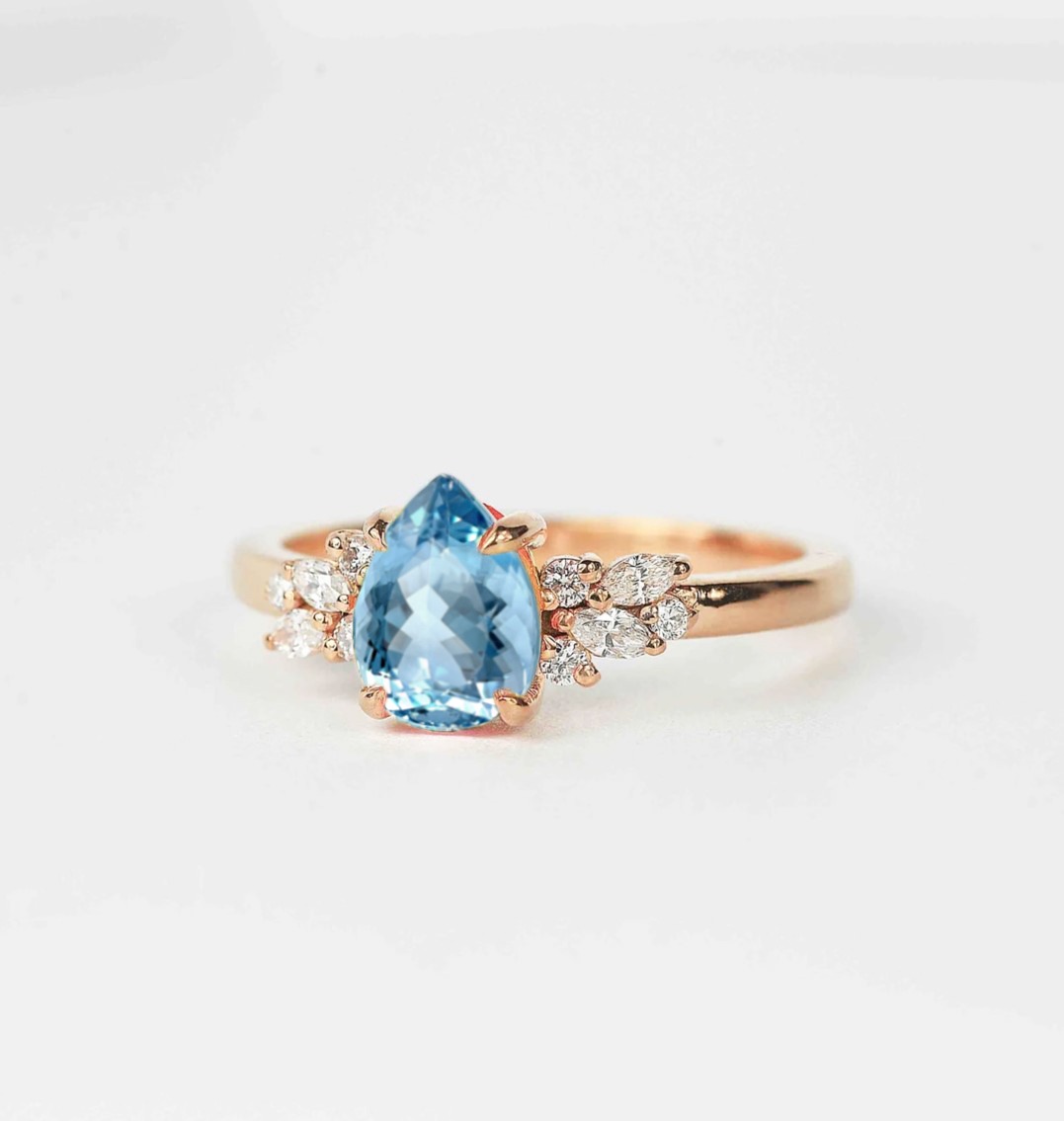 pear aquamarine and diamond ring with aquamarine and white accent diamonds. This unique art deco ring comes with solid 9k,14k or 18k rose gold.