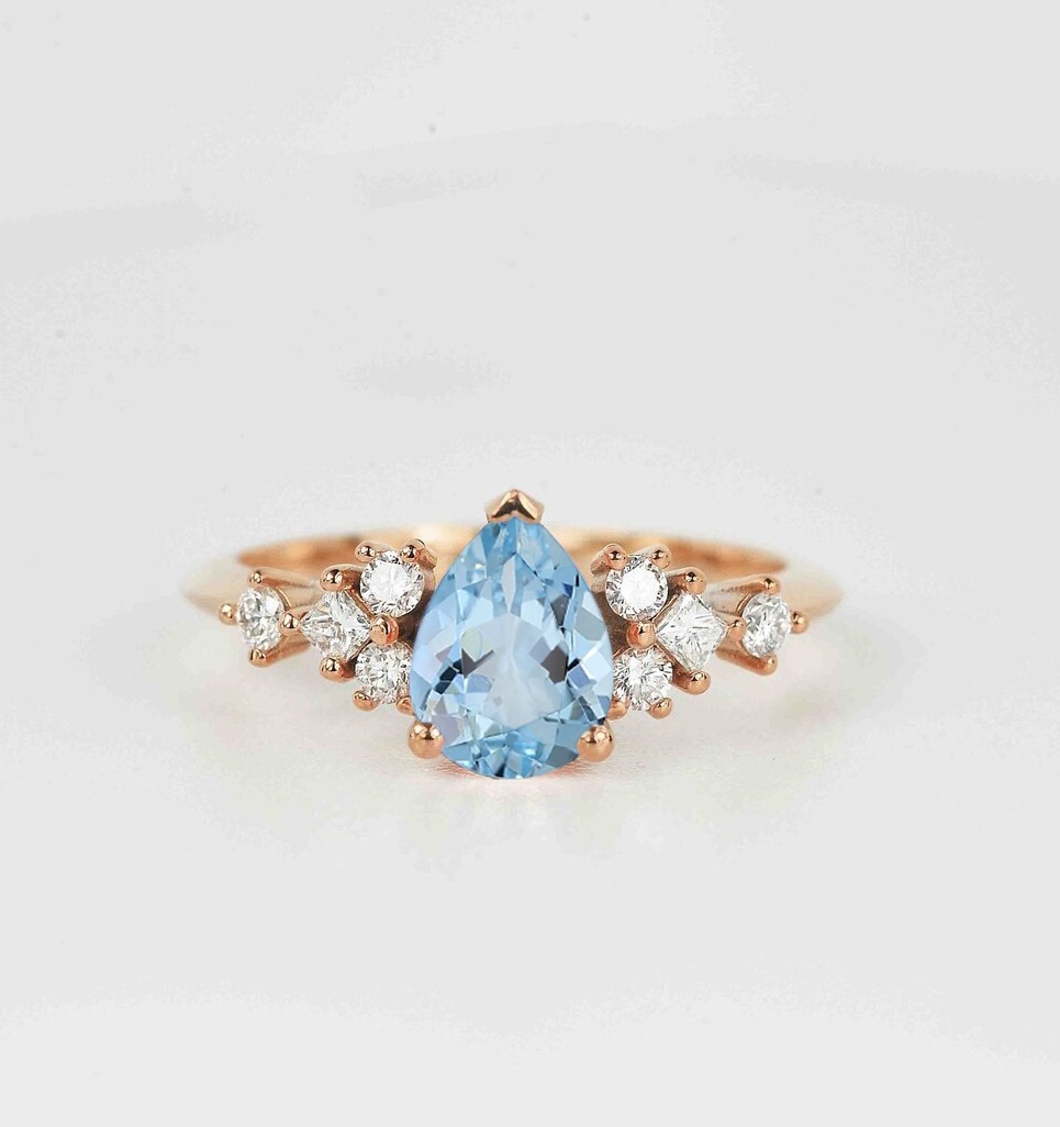 This beautiful pear cut aquamarine and diamond ring comes with a center 1.50ct aquamarine and white natural diamonds. Available in rose gold, yellow gold, white gold, or platinum.