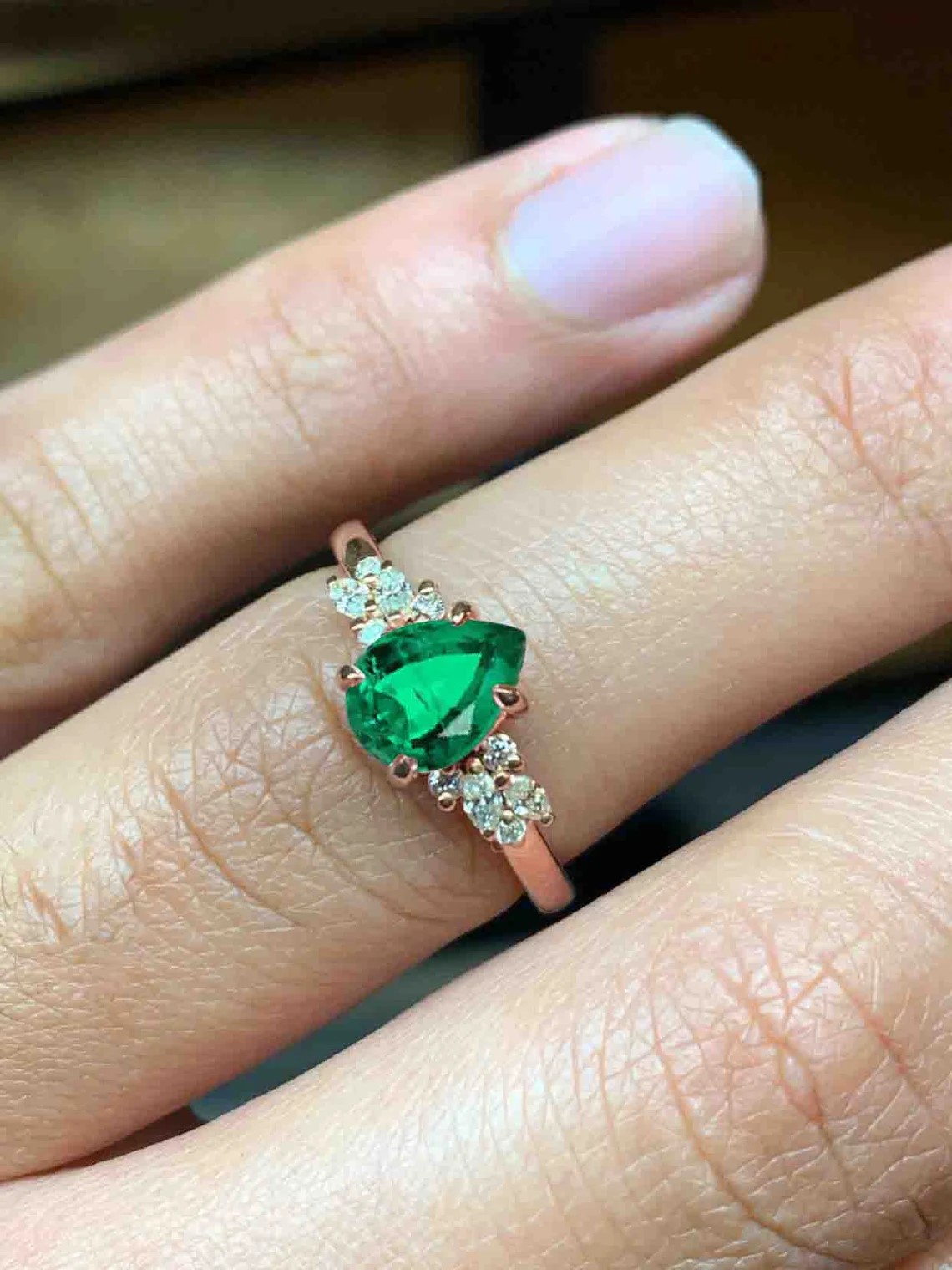 emerald and diamond luxury cluster ring with 8 x 6mm emerald and white accent diamonds. The unique design of this art deco style ring comes with solid 9k,14k or 18k gold or platinum.