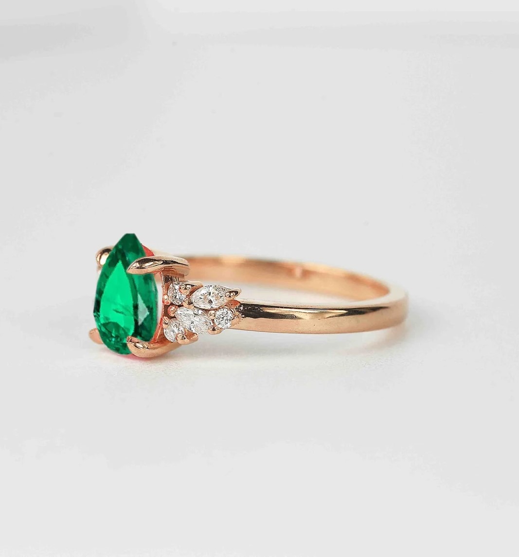 emerald and diamond luxury cluster ring with 8 x 6mm emerald and white accent diamonds. The unique design of this art deco style ring comes with solid 9k,14k or 18k gold or platinum.
