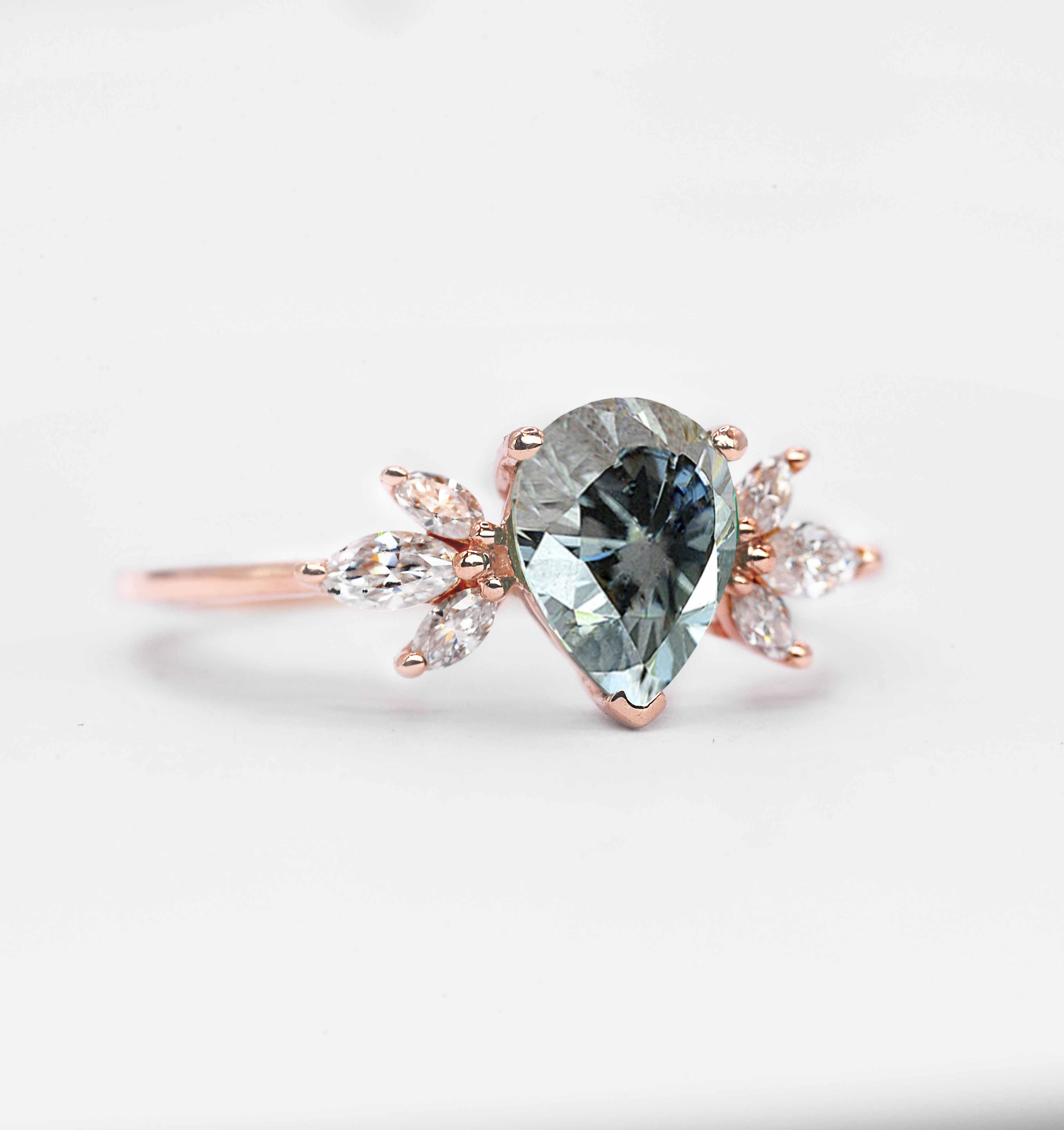 pear cut grey moissanite ring with 8 x 6mm peat cut moissanite and white marquise diamonds. The unique design of this art deco style ring comes with solid 9k,14k or 18k gold or platinum.