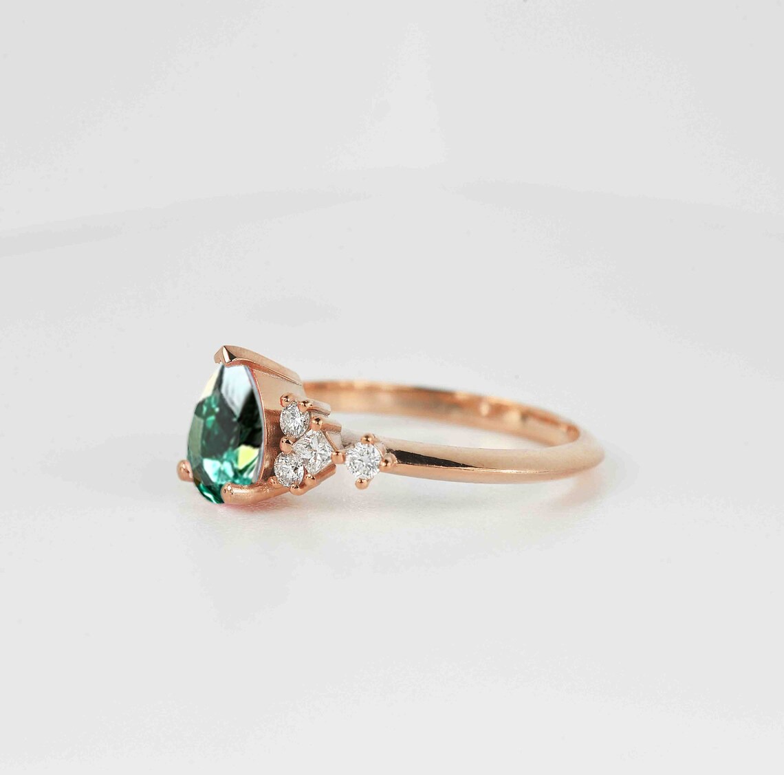 This beautiful pear cut mint green sapphire ring comes with a center 1.50ct mint green sapphire and white natural diamonds. Available in rose gold, yellow gold, white gold, or platinum.