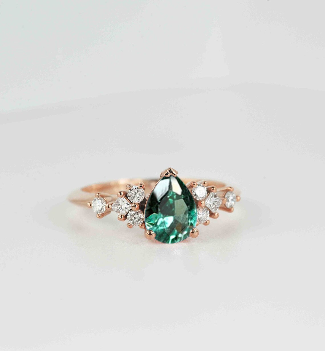 This beautiful pear cut mint green sapphire ring comes with a center 1.50ct mint green sapphire and white natural diamonds. Available in rose gold, yellow gold, white gold, or platinum.