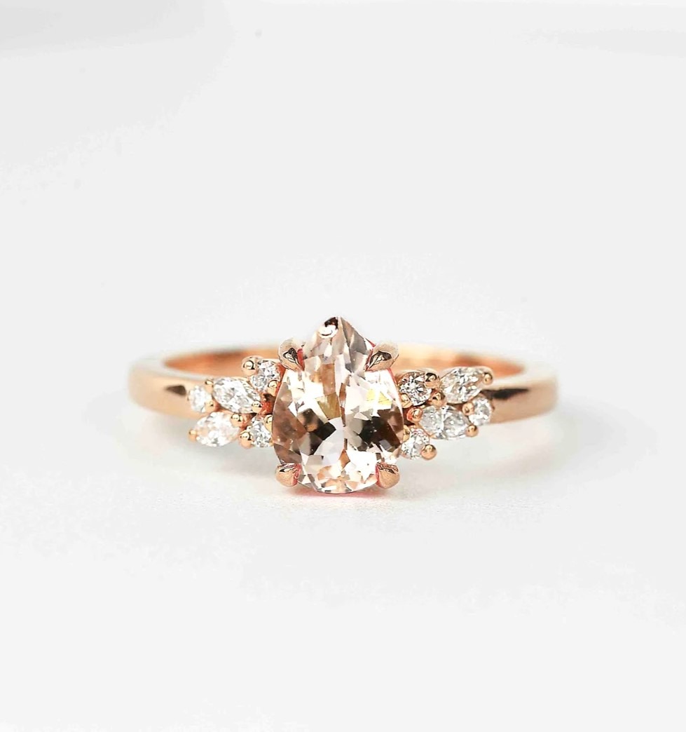 Pear cut 1.5ct morganite and diamond ring with morganite and white accent diamonds. This unique art deco ring comes with solid 9k,14k or 18k rose gold.