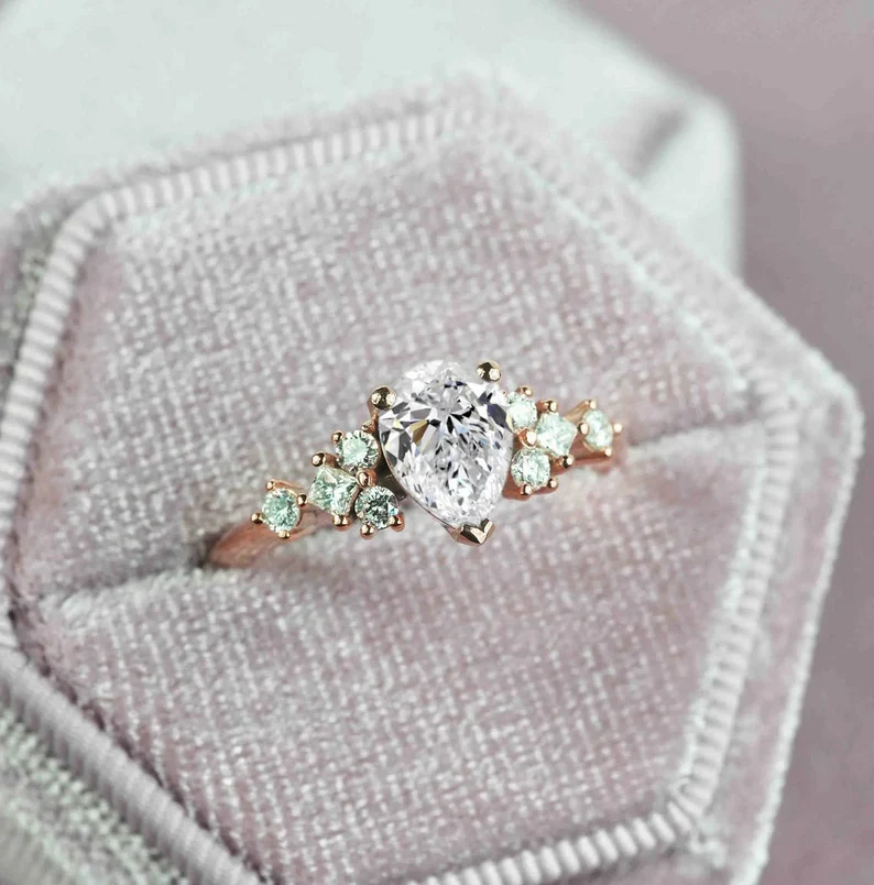 This beautiful pear cut diamond unique ring comes with a center 1.50ct lab grown diamond and white natural diamonds. Available in rose gold, yellow gold, white gold, or platinum.