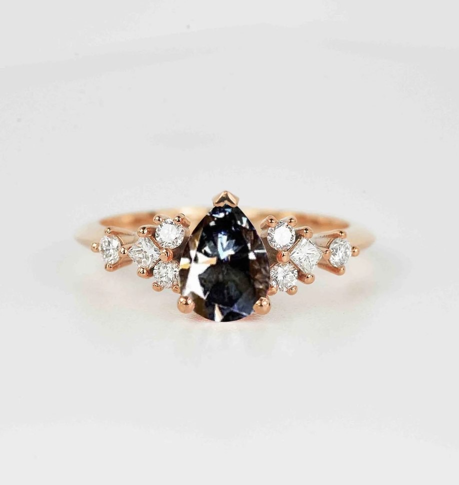 A grey moissanite cluster ring. 8 x 6mm pear cut grey moissanite comes with 2mm round diamonds and 2mm princess cut diamonds.