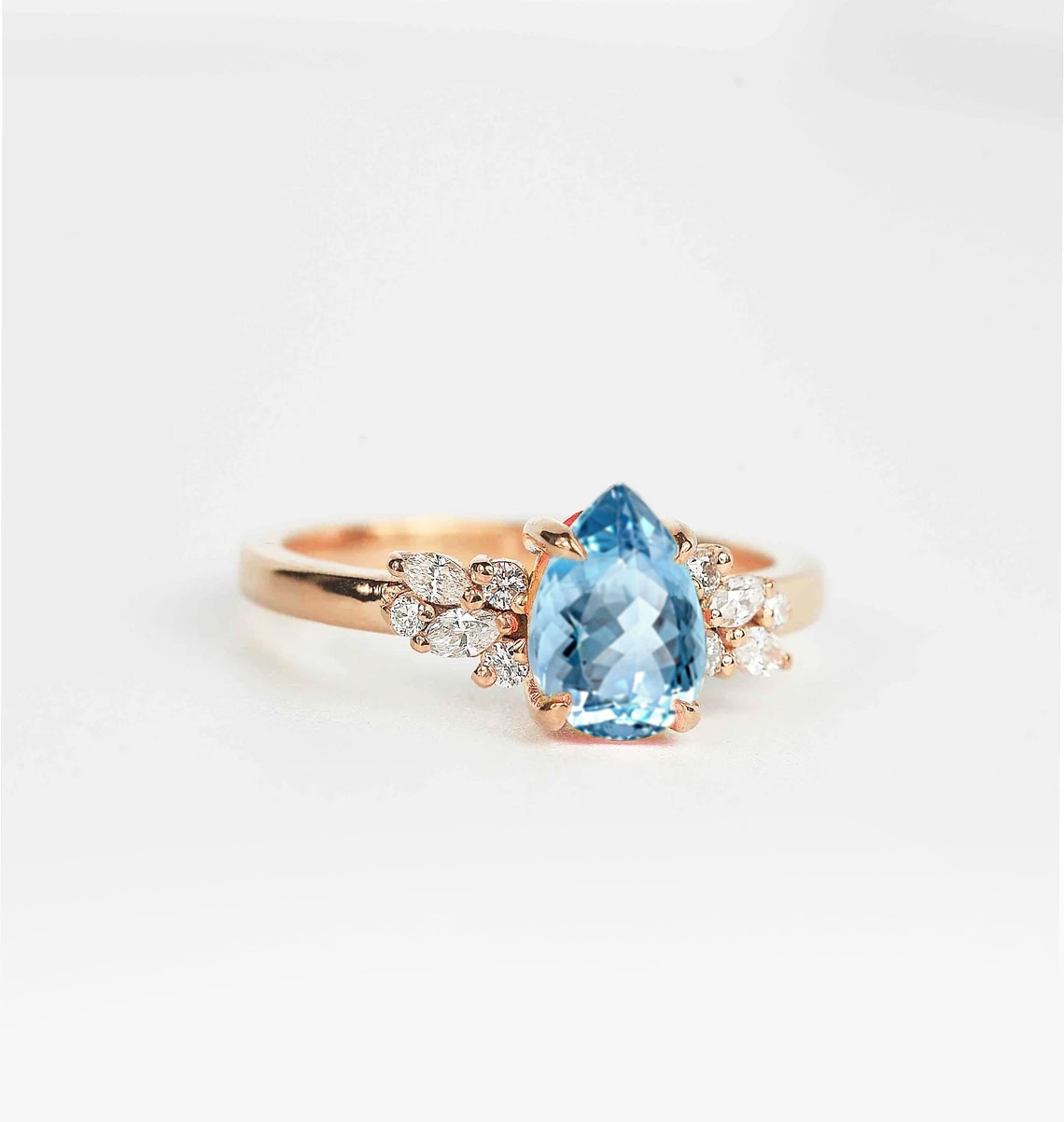 pear aquamarine and diamond ring with aquamarine and white accent diamonds. This unique art deco ring comes with solid 9k,14k or 18k rose gold.