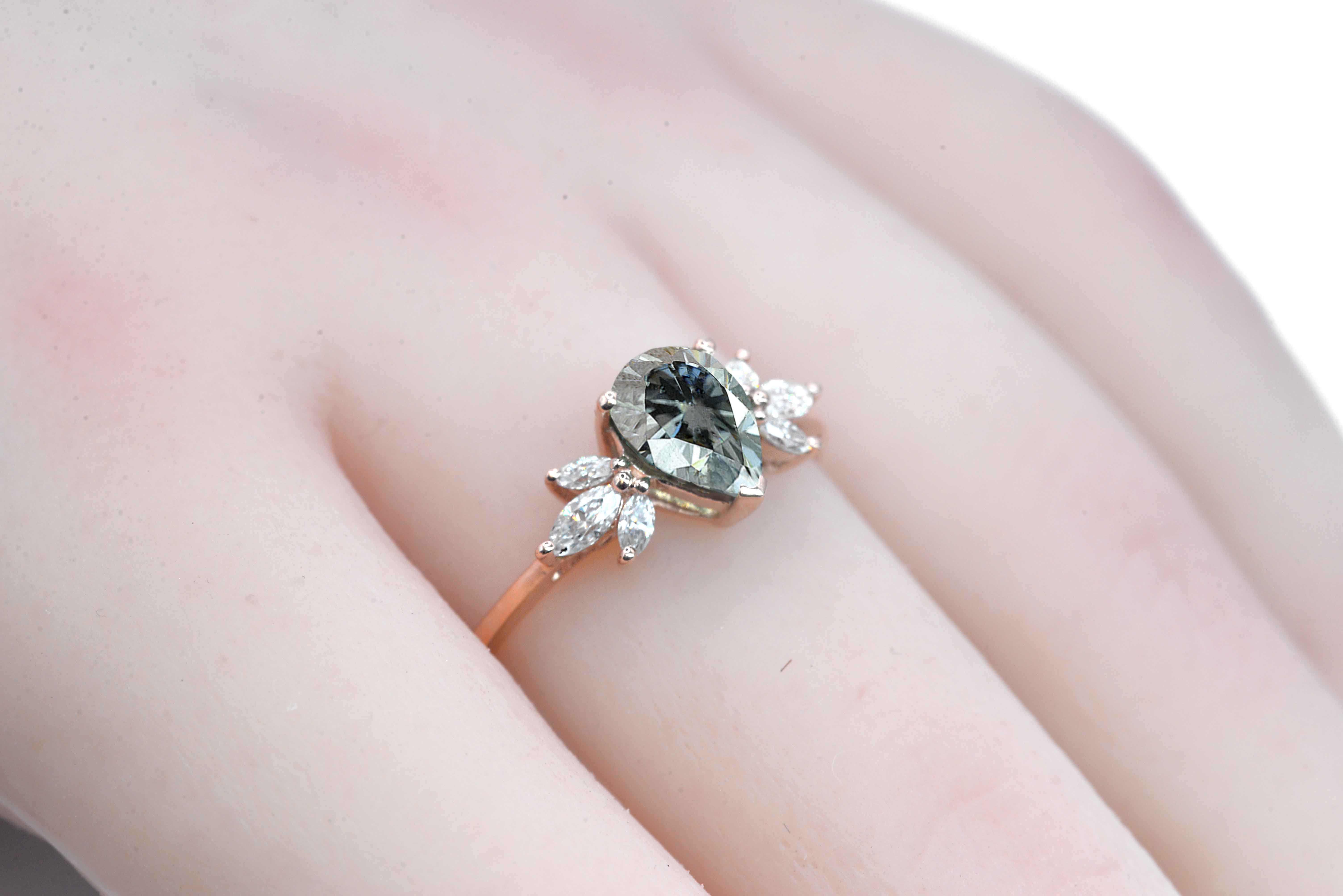 pear cut grey moissanite ring with 8 x 6mm peat cut moissanite and white marquise diamonds. The unique design of this art deco style ring comes with solid 9k,14k or 18k gold or platinum.