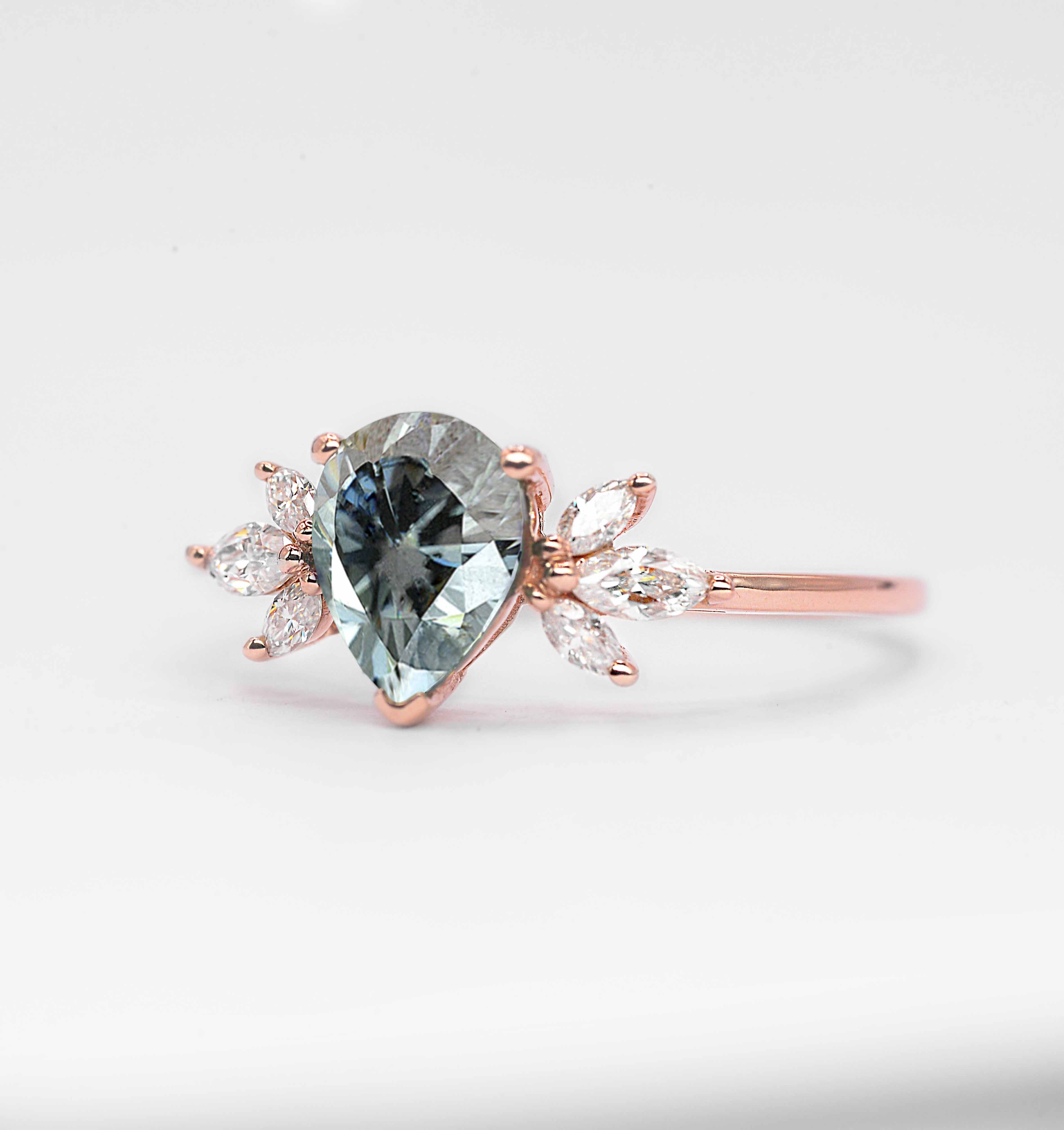 pear cut grey moissanite ring with 8 x 6mm peat cut moissanite and white marquise diamonds. The unique design of this art deco style ring comes with solid 9k,14k or 18k gold or platinum.