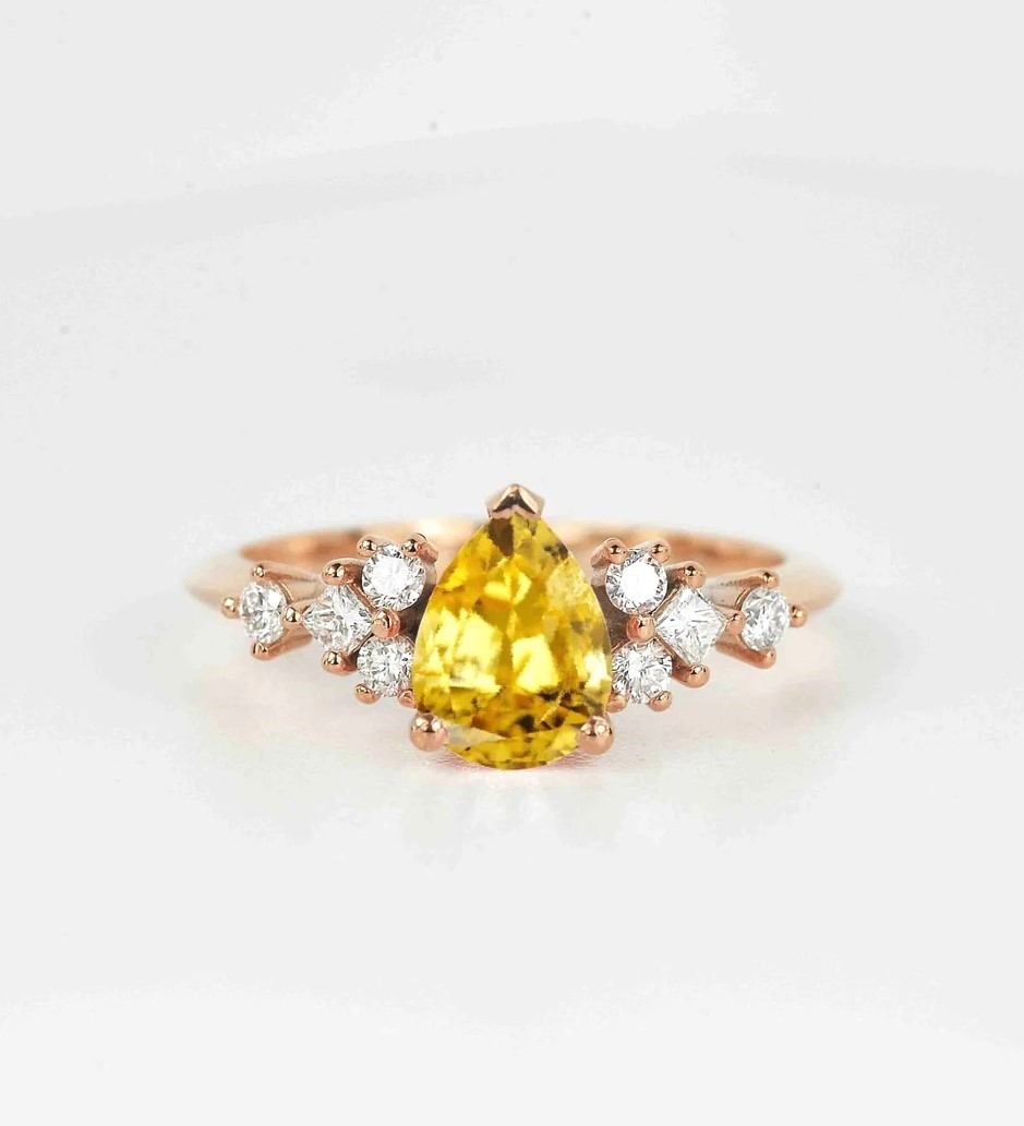 yellow sapphire and diamond cluster ring with 8 x 6mm yellow sapphire and white accent diamonds. The unique design of this art deco style ring comes with solid 9k,14k or 18k gold or platinum.