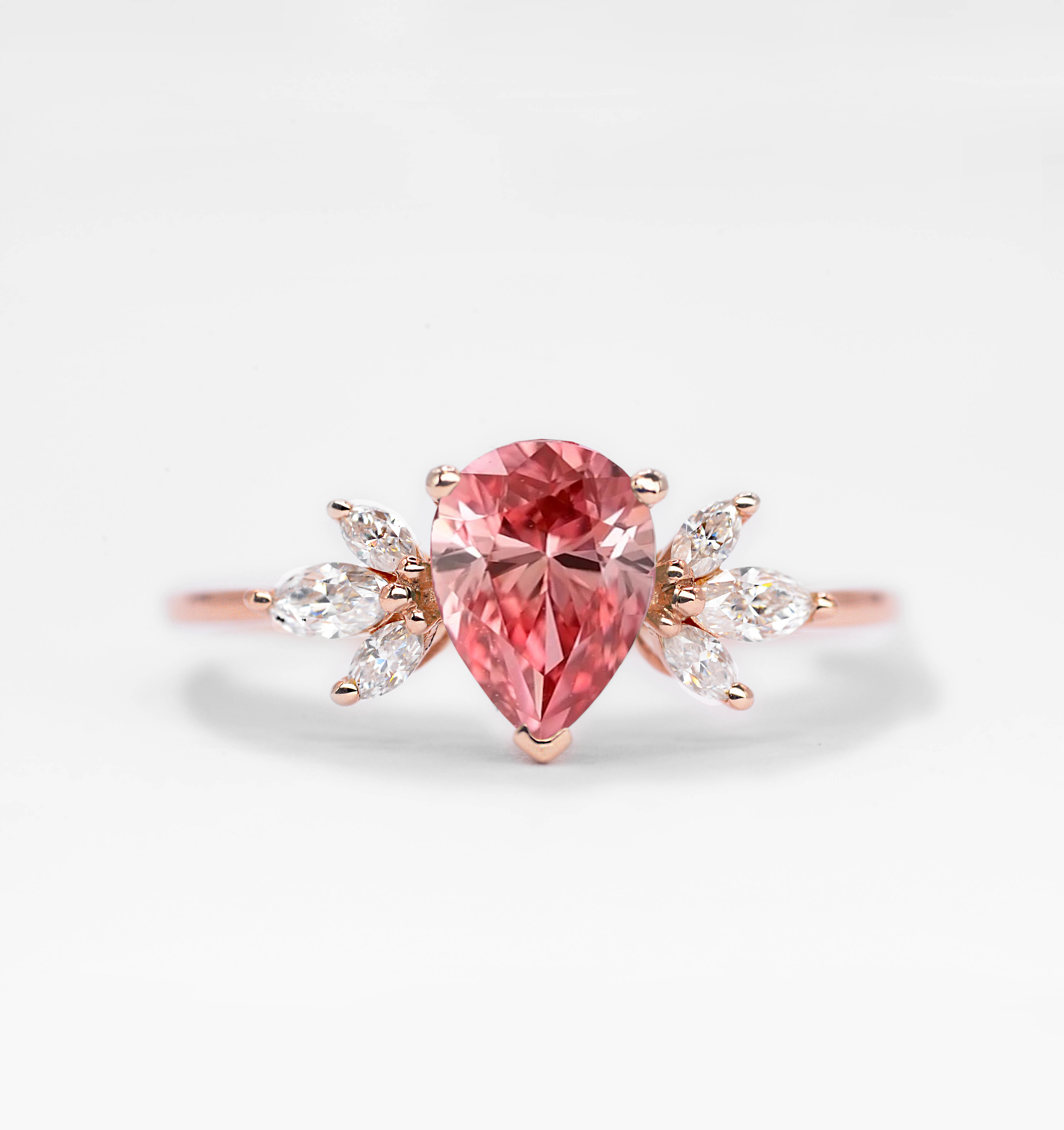 Pear cut padparadscha engagement ring with 8 x 6mm peat cut padparadscha sapphire and white marquise diamonds. The unique design of this art deco style ring comes with solid 9k,14k or 18k gold or platinum.