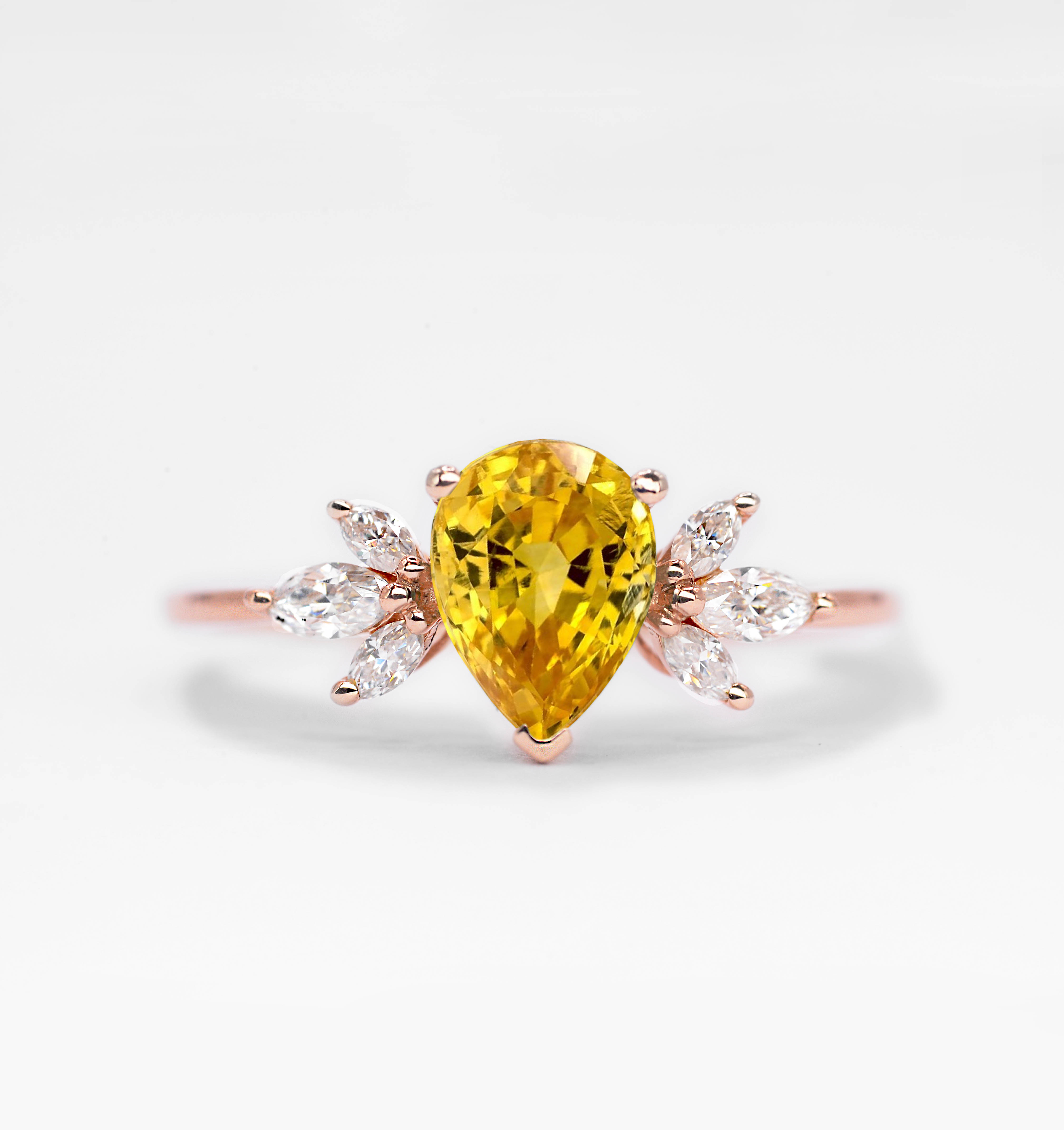 This yellow sapphire cluster ring for her comes with a center yellow sapphire and white natural diamonds is a beautiful and elegant choice for engagement or any other occasion. Available in rose gold, yellow gold, white gold, or platinum.