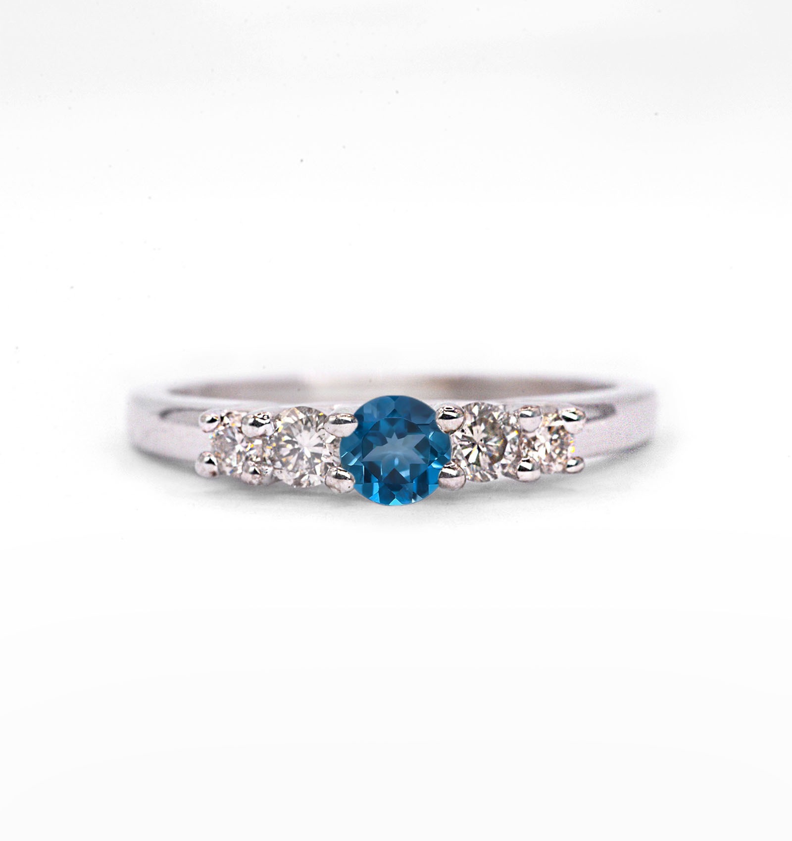 This natural blue topaz and diamond ring featuring round natural blue topaz and white diamonds. A beautiful and elegant ring for engagement or any other occasion. Available in rose gold, yellow gold, white gold, or platinum.