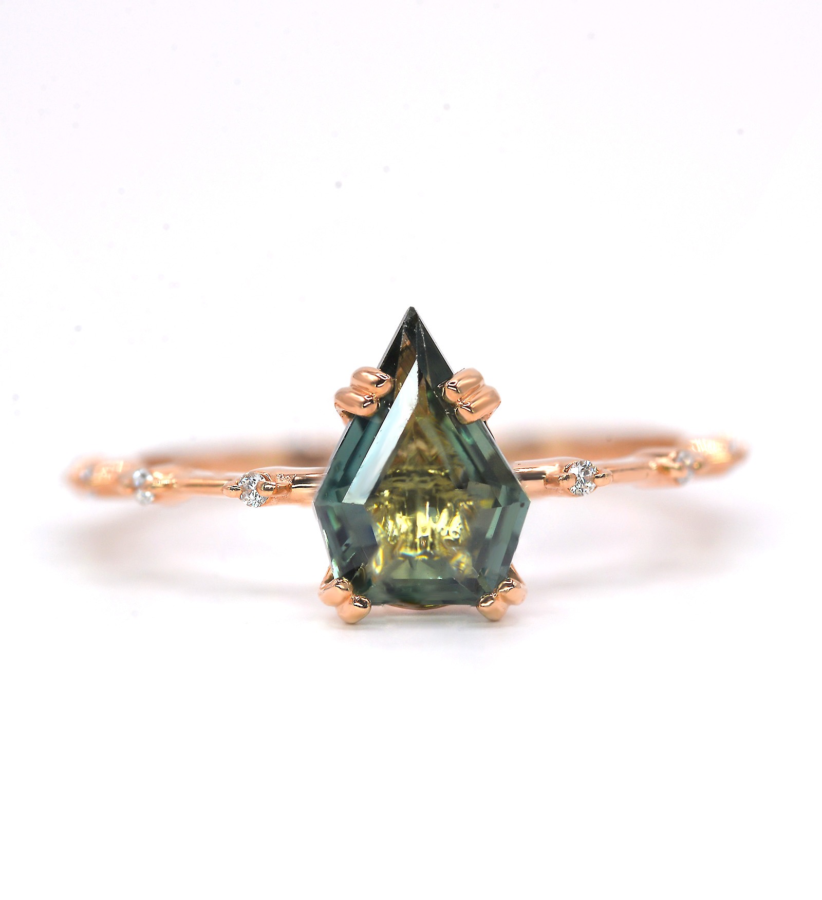 Our Modern and minimalist teal sapphire ring showcases an unconventional sapphire cut, glowing in shades of teal that shift beautifully with the light. Each gemstone is hand-selected for its distinct color and character — no two are alike. Designed for the modern romantic, this ring is a bold, meaningful symbol of individuality and deep connection.