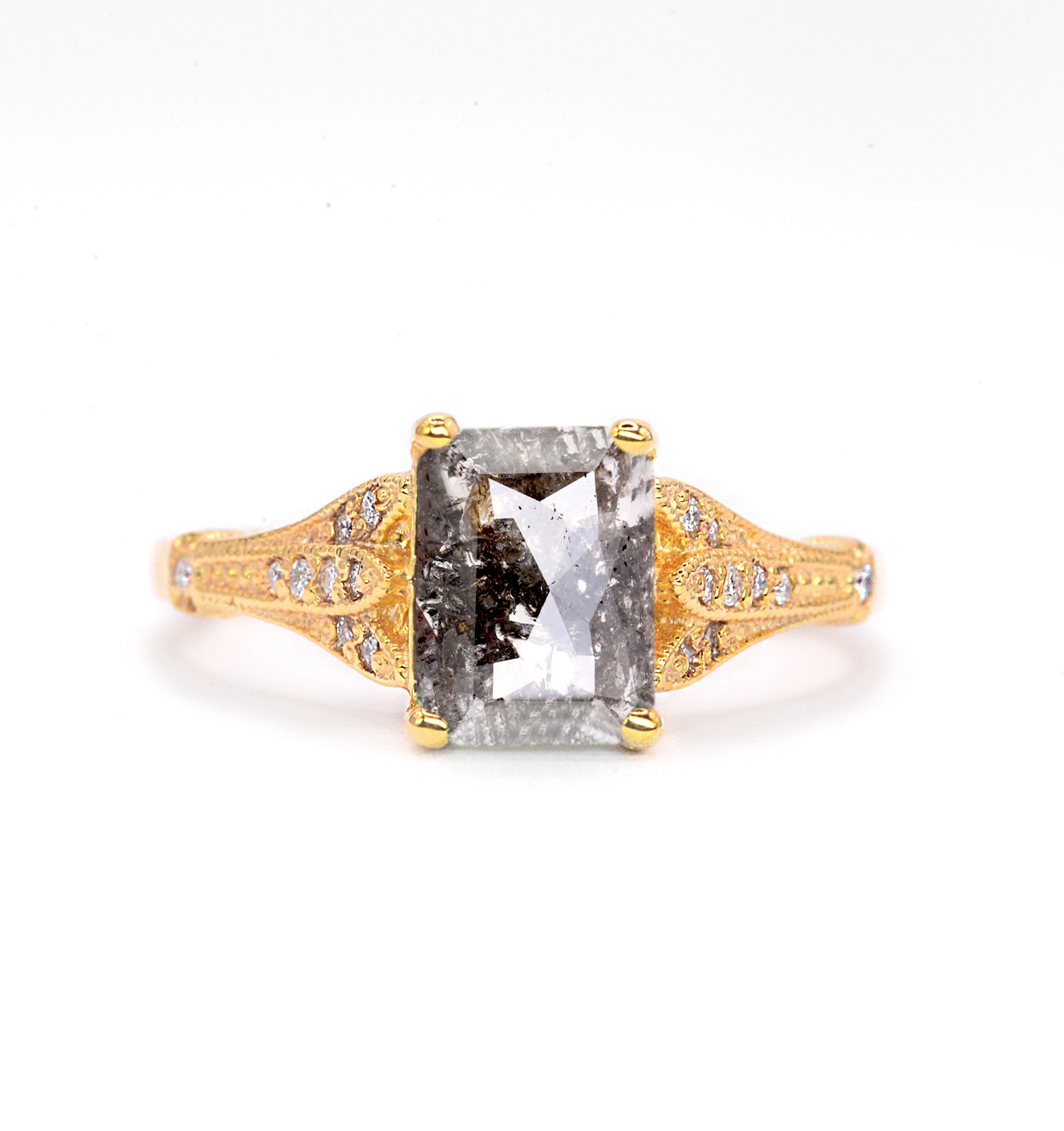 This emerald shape salt and pepper diamond ring is a beautiful and elegant choice for engagement or any other occasion. Available in rose gold, yellow gold, white gold, or platinum.